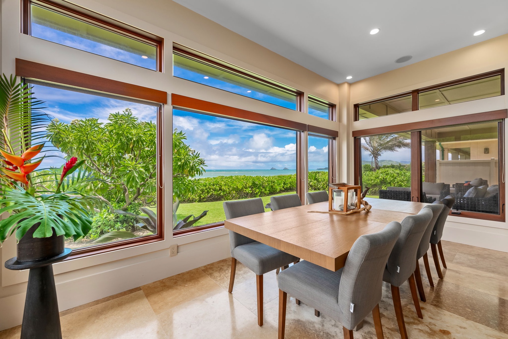 Kailua Vacation Rentals, Makalei - The modern dining area featuring a table for ten and 180-degree view of the ocean, including a view of the Mokuluas.