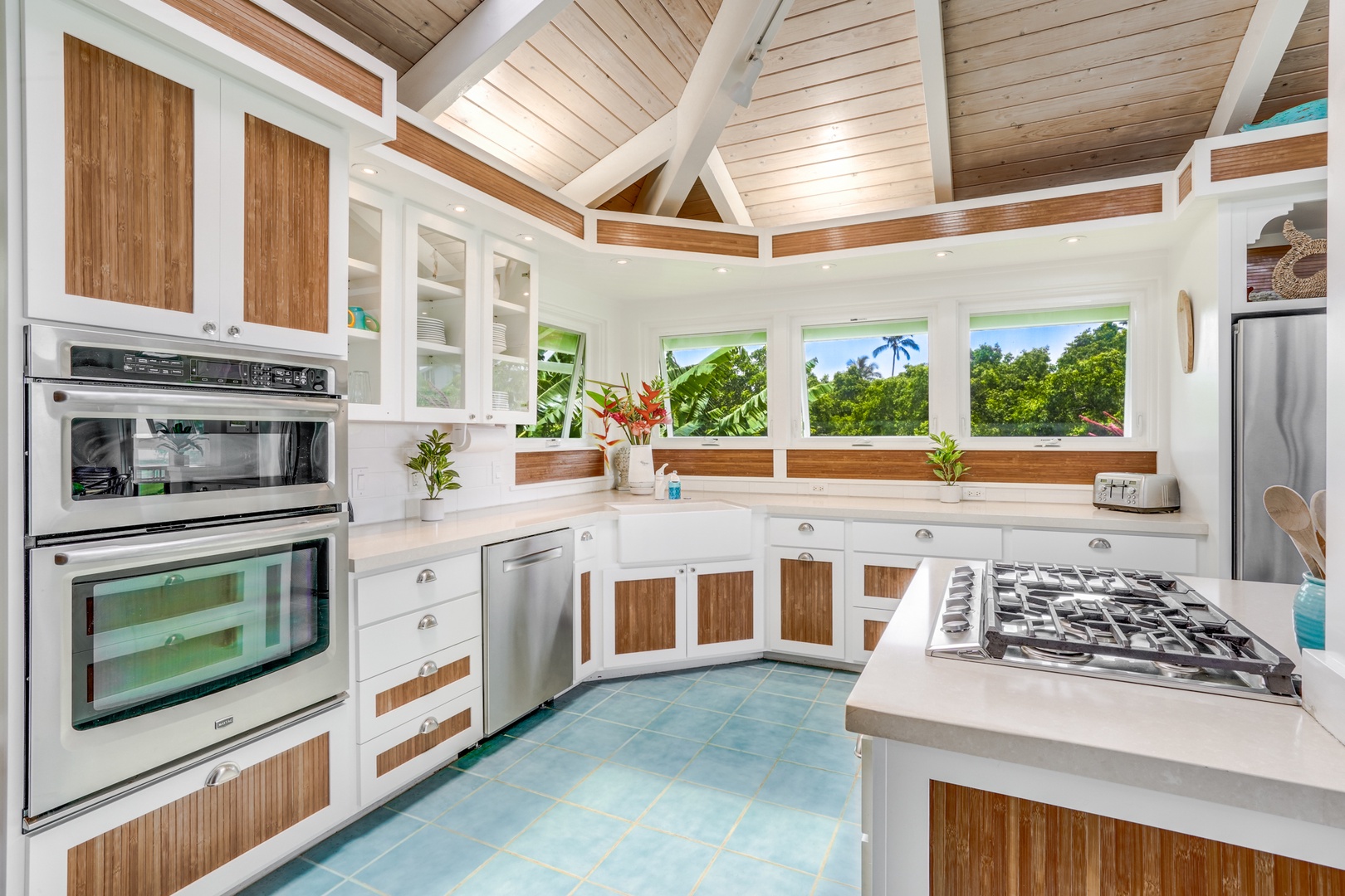 Princeville Vacation Rentals, Wai Lani - Kitchen area with top-tiered appliances, wide counter space and panoramic vistas as you prep delightful meals.