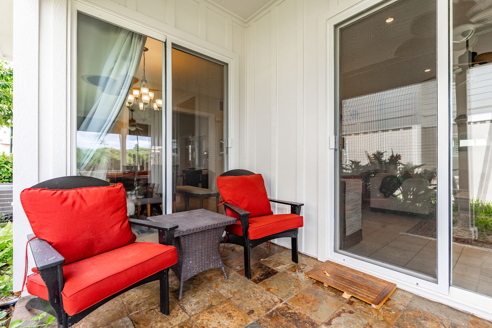 Kapolei Vacation Rentals, Coconut Plantation 1080-4 - Red-cushioned chairs on the lanai for the in-between hours with a cold drink.