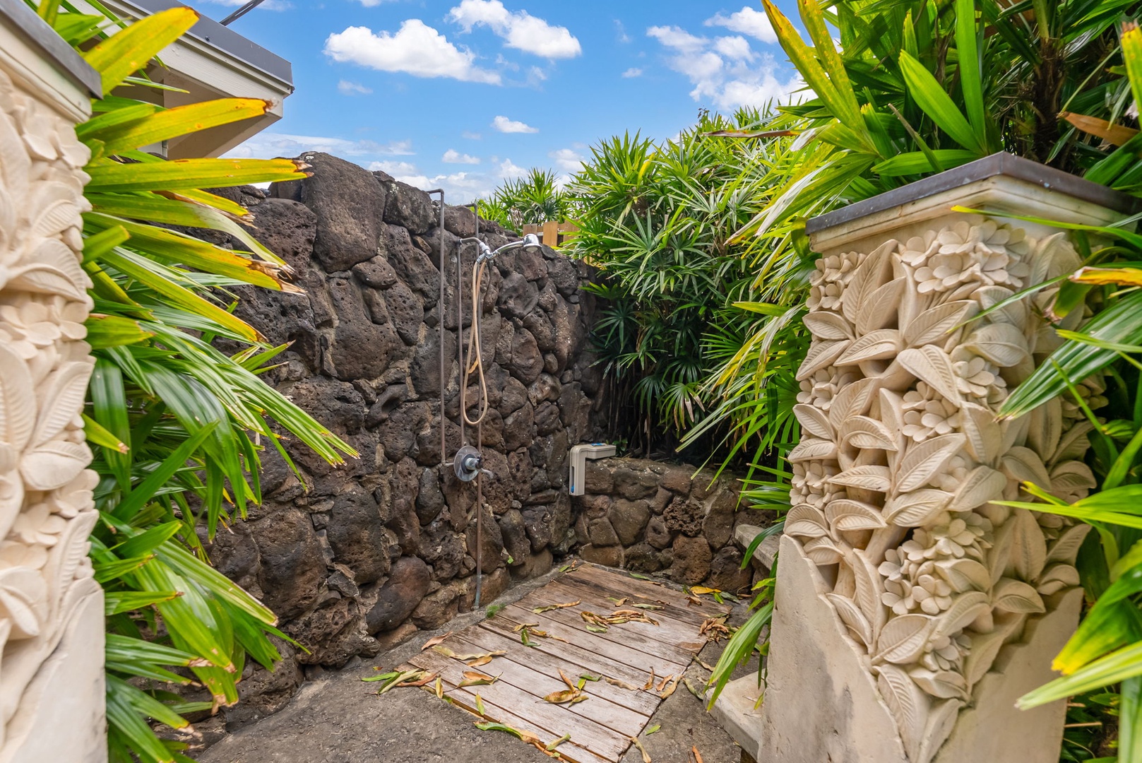 Kailua Vacation Rentals, Leaf House - Rinse off beneath the open sky in your private outdoor shower, where natural lava rock walls and lush tropical greenery create a secluded, spa-like escape.