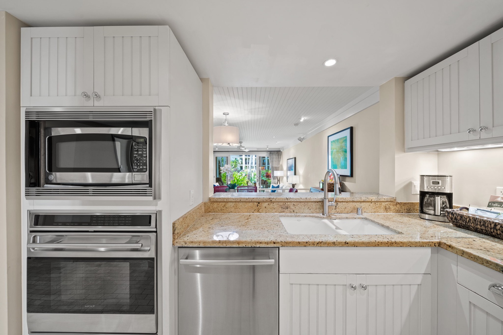 Kahuku Vacation Rentals, Turtle Bay Villas 114 - The kitchen overlooks the dining and living areas with peekaboo garden views