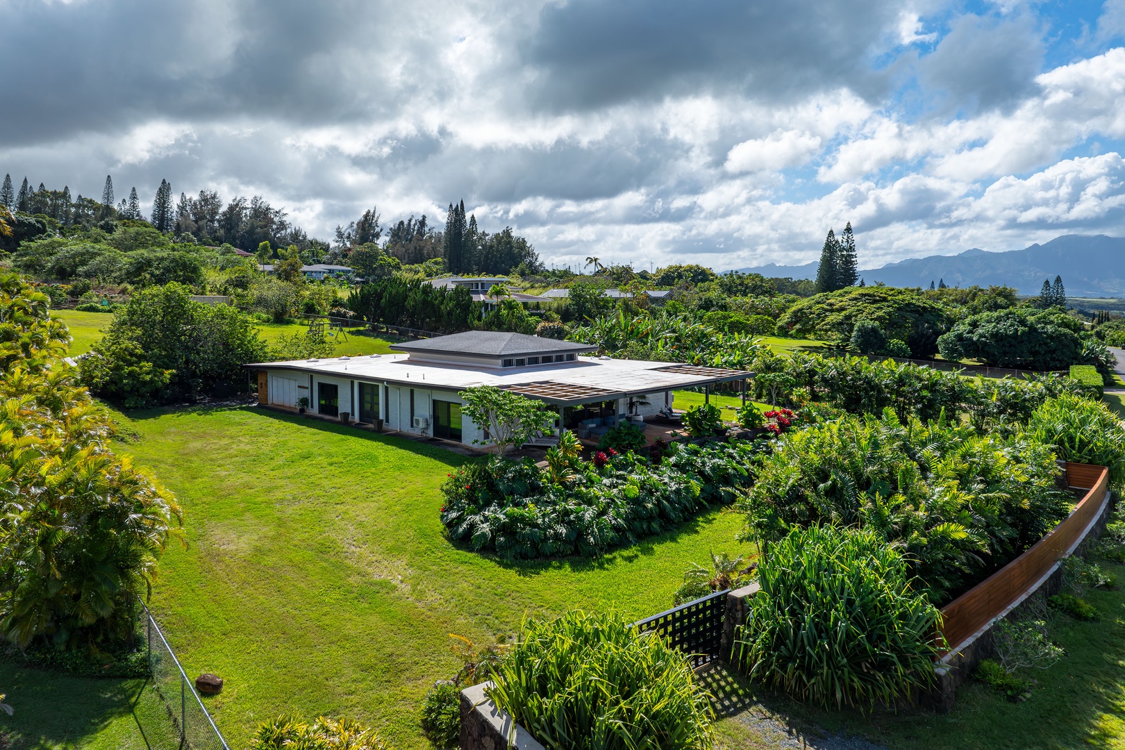 Haleiwa Vacation Rentals, Hale Mahina - Discover the home’s lush setting from above, surrounded by tropical greenery and open space.