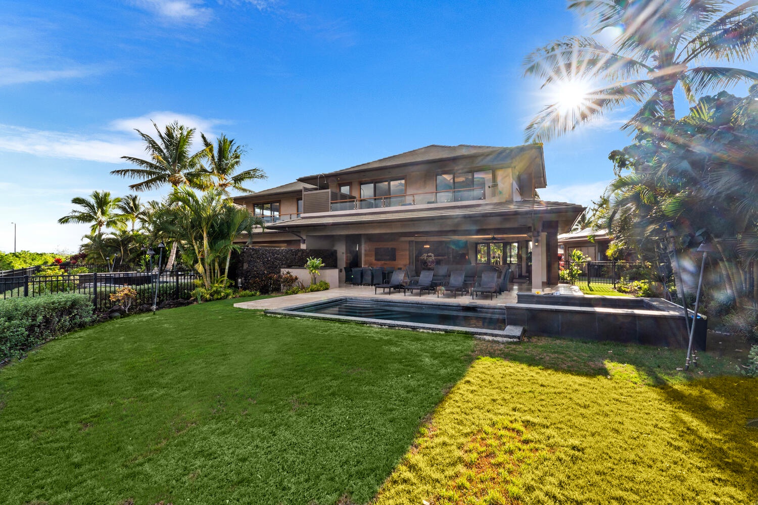 Kamuela Vacation Rentals, Laule'a Ohana Retreat - Backyard view showcasing the wide green lawn and sunny setting at Laule'a #13.