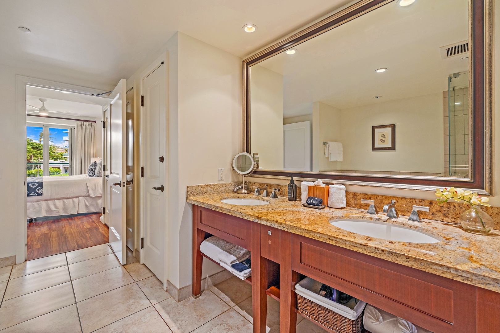 Lahaina Vacation Rentals, Honua Kai Konea 206 - The bathroom features a spacious double vanity with granite countertops and ample storage, providing both style and convenience for your stay.