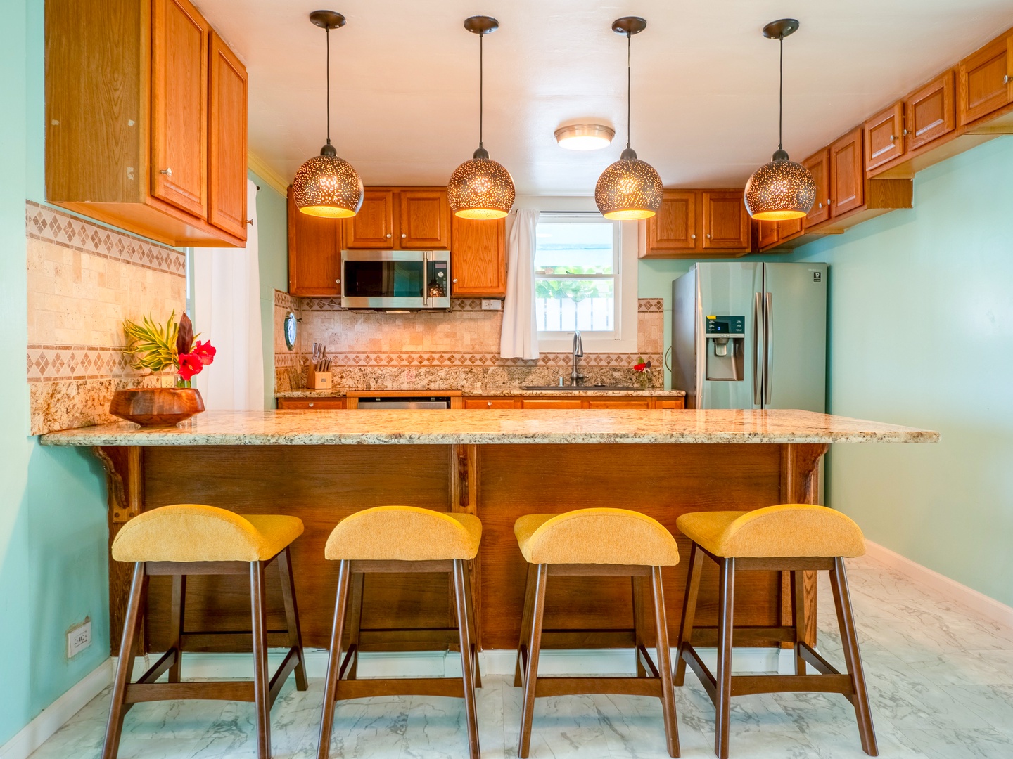Hauula Vacation Rentals, Paradise Reef Retreat - Chic kitchen bar/island, the perfect spot for sharing quick bites and laughter, all while enjoying top-notch entertainment.