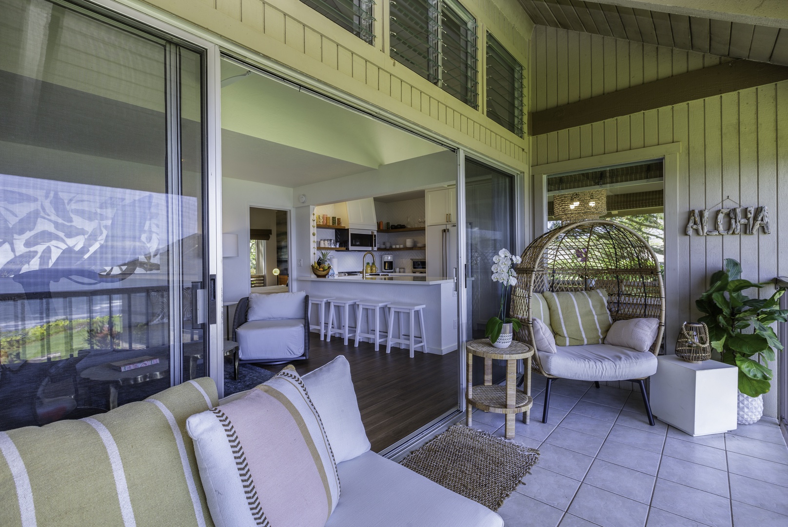 Princeville Vacation Rentals, Pali Ke Kua 207 - Expansive glass sliders connect the living room to the sizable lanai, where ocean breezes, sea and garden views, and outdoor dining options await you
