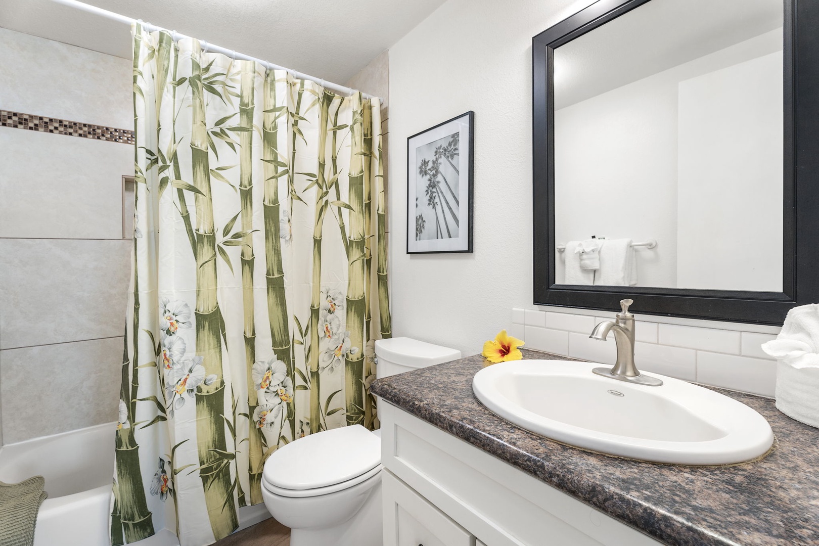 Kailua Kona Vacation Rentals, Sea Village 4213 - Primary ensuite with tropical touches, granite vanity, and full tub/shower combo.