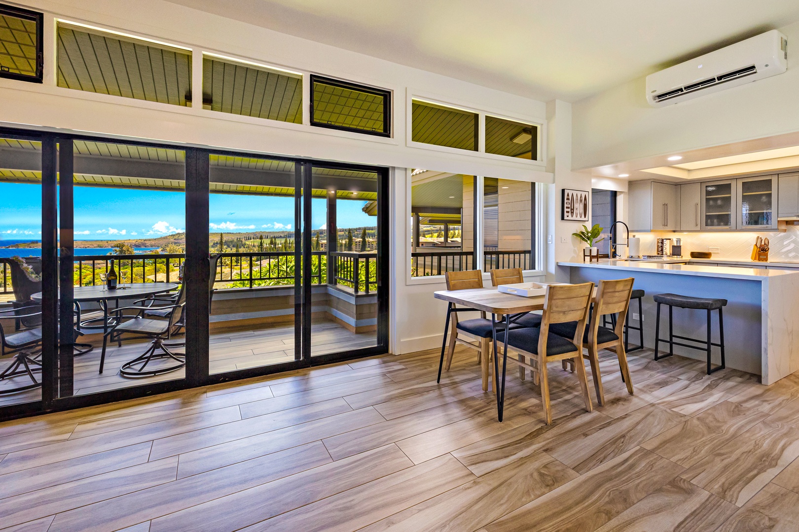 Lahaina Vacation Rentals, Kapalua Ridge 1421 - Enjoy your meals with a stunning ocean view from this dining area, featuring floor-to-ceiling windows and easy access to the outdoor lanai