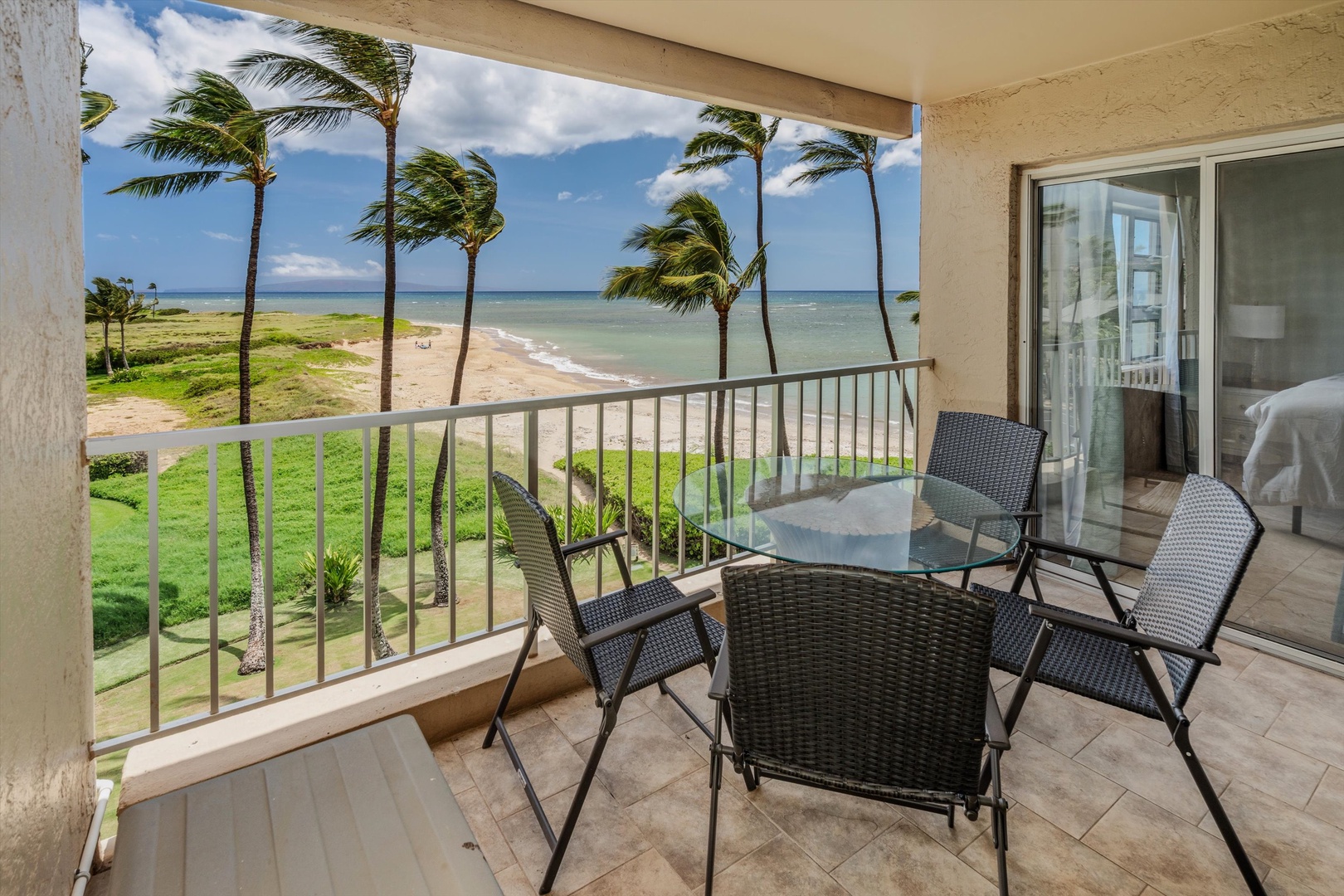 Kihei Vacation Rentals, Menehune Shores 420 - From the lanai, the beach and reef spread out under a row of leaning palms.