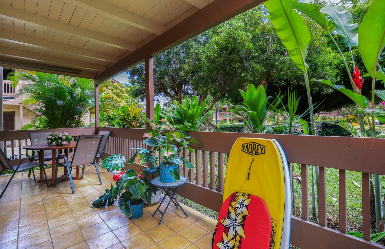 Princeville Vacation Rentals, Hideaway Haven - Savor your morning coffee on the tranquil lanai, complete with beach skim boards for those inspired to ride the waves.