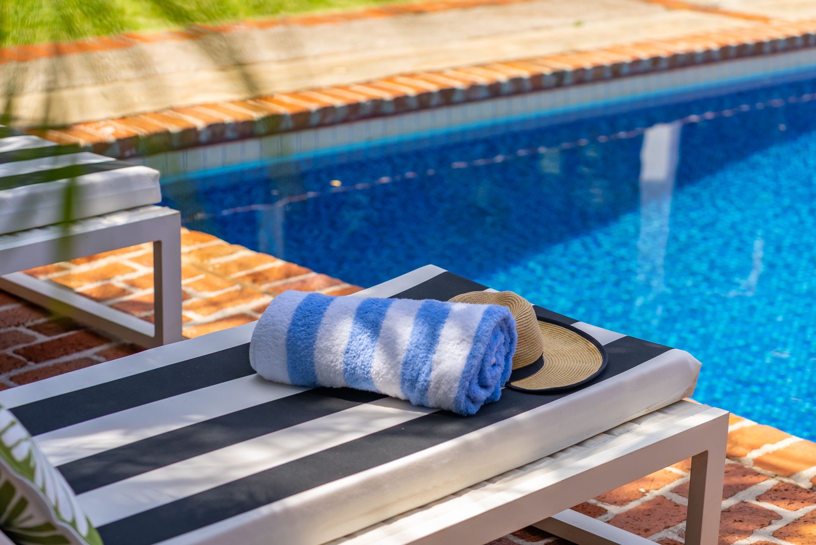 Honolulu Vacation Rentals, Ho'okipa Villa - Your sun-soaked poolside retreat awaits—lounge in comfort with a refreshing swim just steps away, towels ready, and warm Mediterranean tiles underfoot.