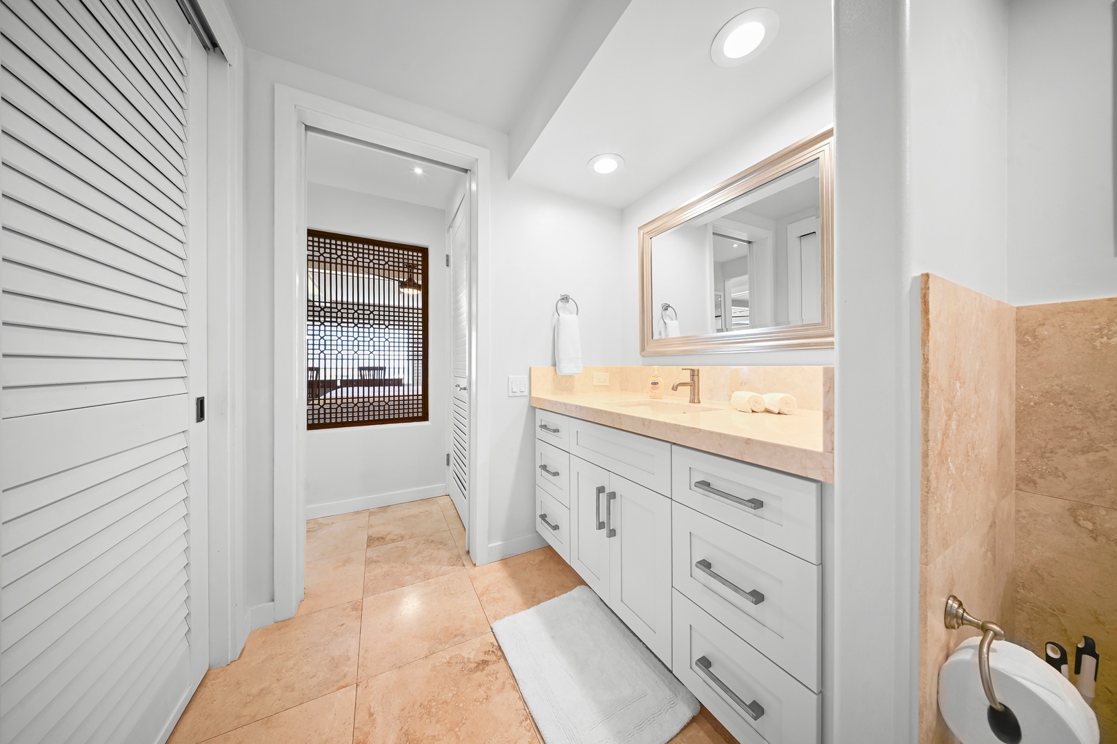 Honolulu Vacation Rentals, Kaimana Shores Getaway - The updated bathroom combines generous vanity space with modern conveniences for a comfortable stay.