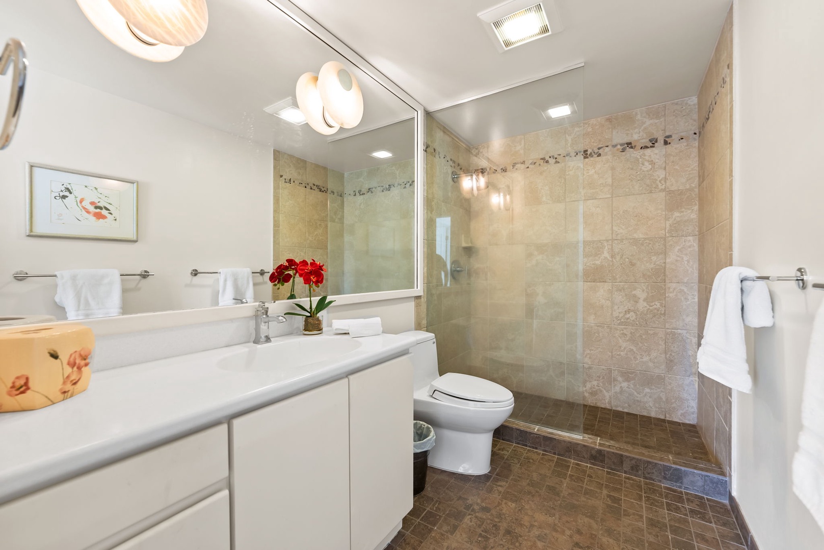 Honolulu Vacation Rentals, Kahala Oasis - Modern bathroom with a glass-enclosed shower and sleek vanity, designed for comfort and convenience.