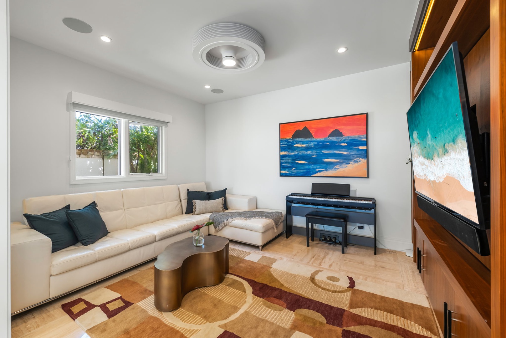 Kailua Vacation Rentals, Lanikai Sunrise Estate - Relax in the TV room with sectional sofa, natural light, and easy access to indoor-outdoor living.