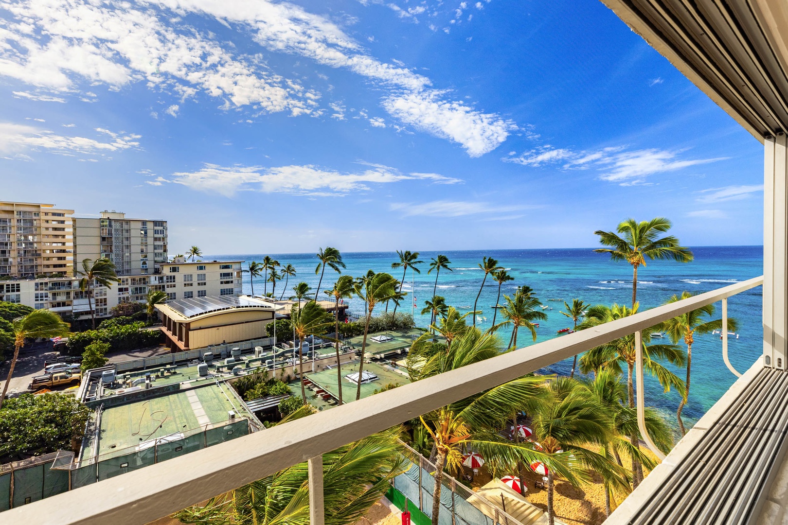 Honolulu Vacation Rentals, Colony Surf Getaway - Relaxing balcony offering expansive tropical views for a serene and exclusive getaway.