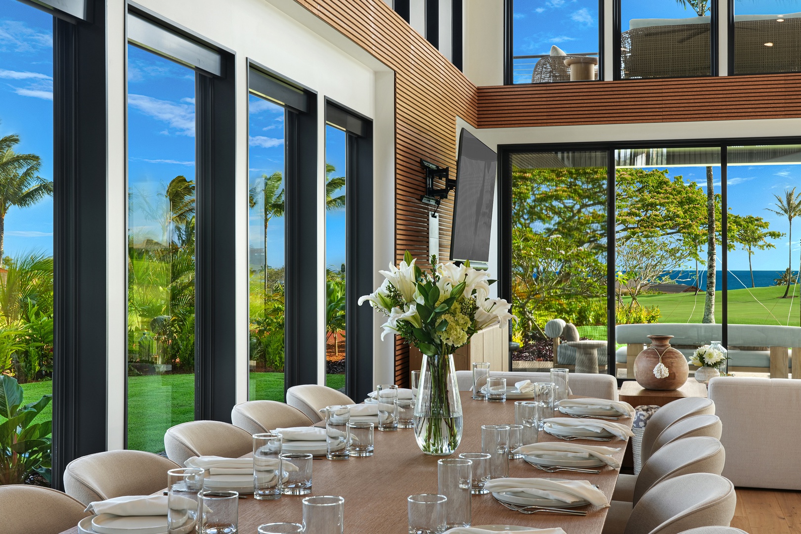 Koloa Vacation Rentals, Hale O Ka Nene - Enjoy relaxed meals around the spacious dining table, surrounded by floor-to-ceiling windows that open to the outdoors and island skies—perfect for slow mornings or sunset dinners with your group.
