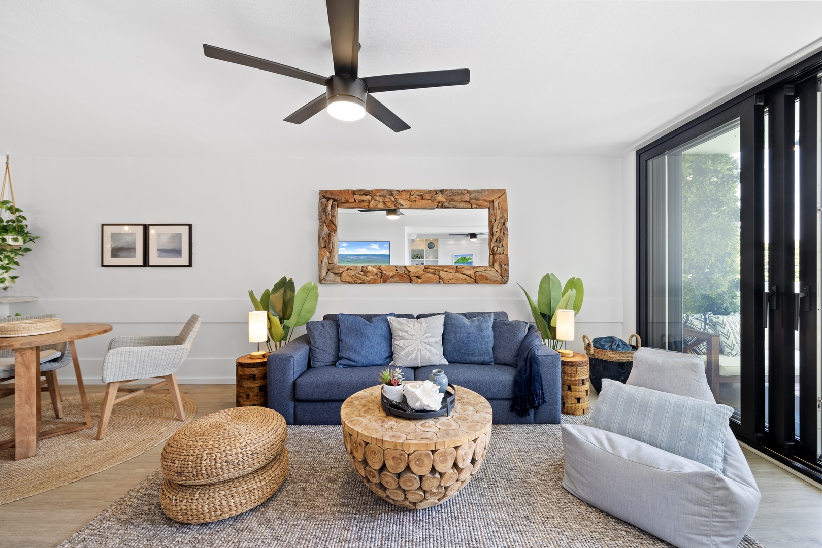 Honolulu Vacation Rentals, Hale Pono Waikiki - Gather and relax in this inviting living area, featuring a plush sofa, unique coffee table, and vibrant natural light.