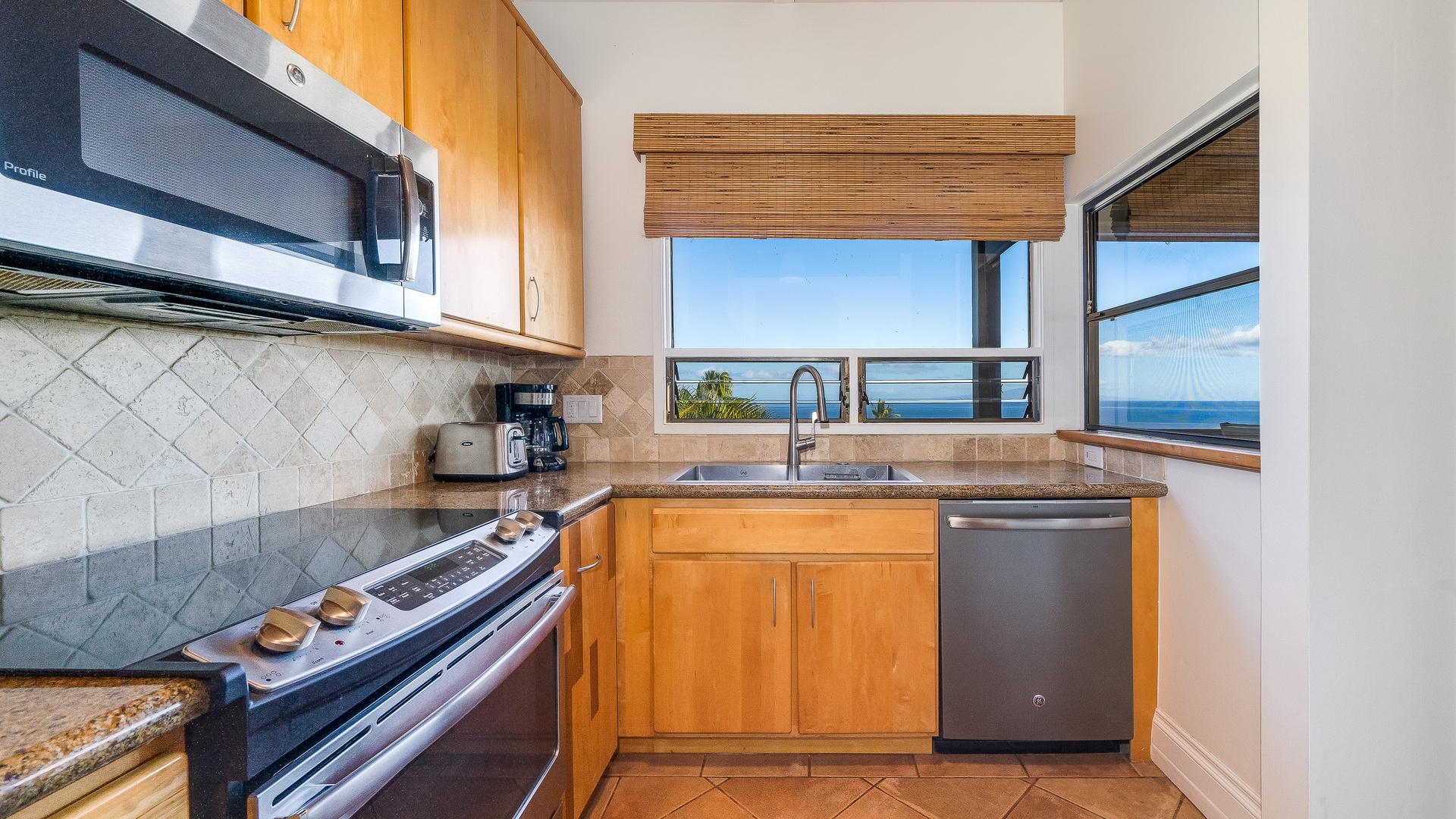 Kihei Vacation Rentals, Wailea Ekolu 1106 - The kitchen offers modern appliances and ocean views, making meal preparation a breeze while enjoying the stunning scenery.