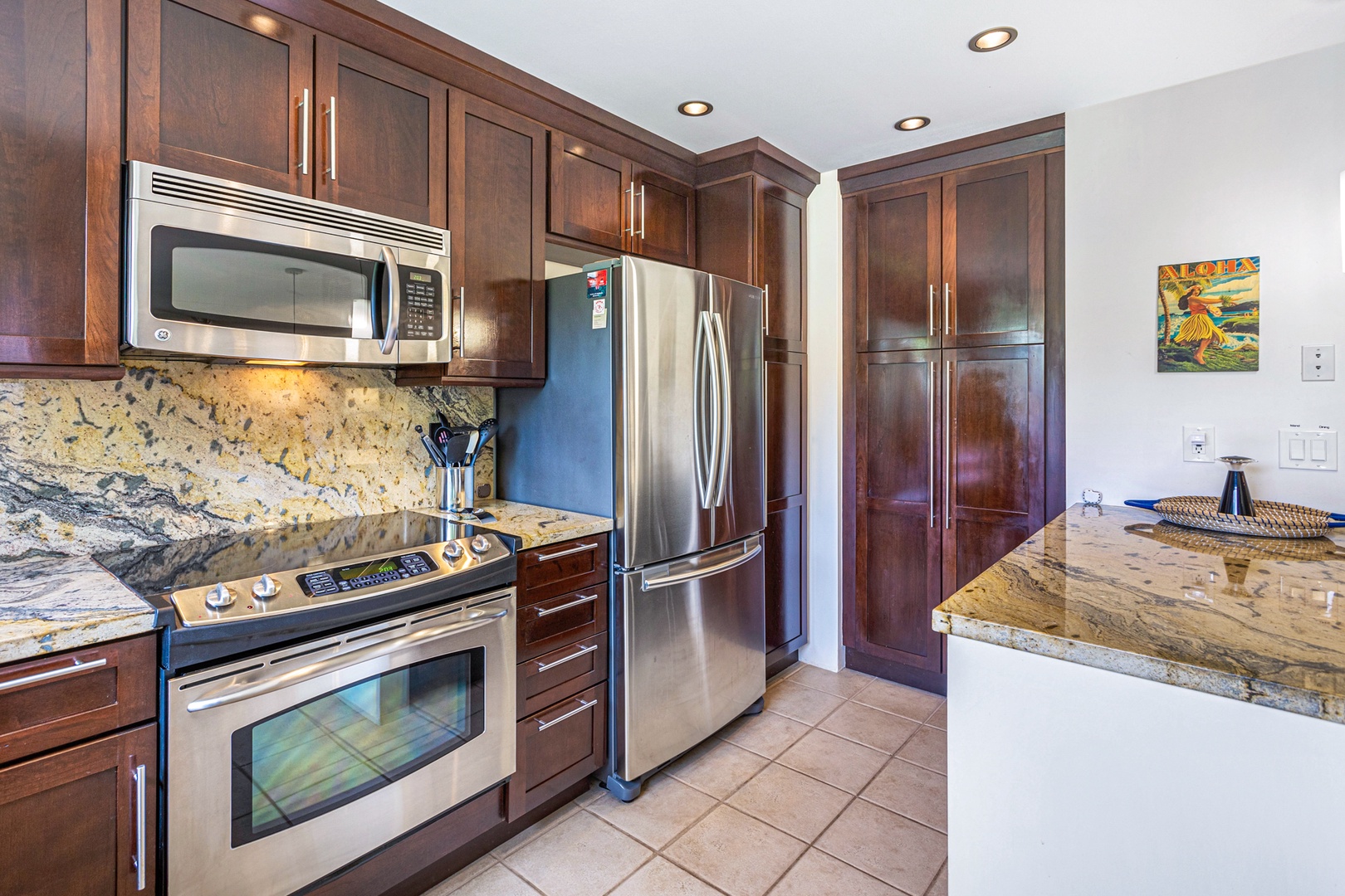 Kihei Vacation Rentals, Wailea Ekolu 1605 - The kitchen offers modern stainless steel appliances and plenty of storage space, perfect for preparing meals during your stay.