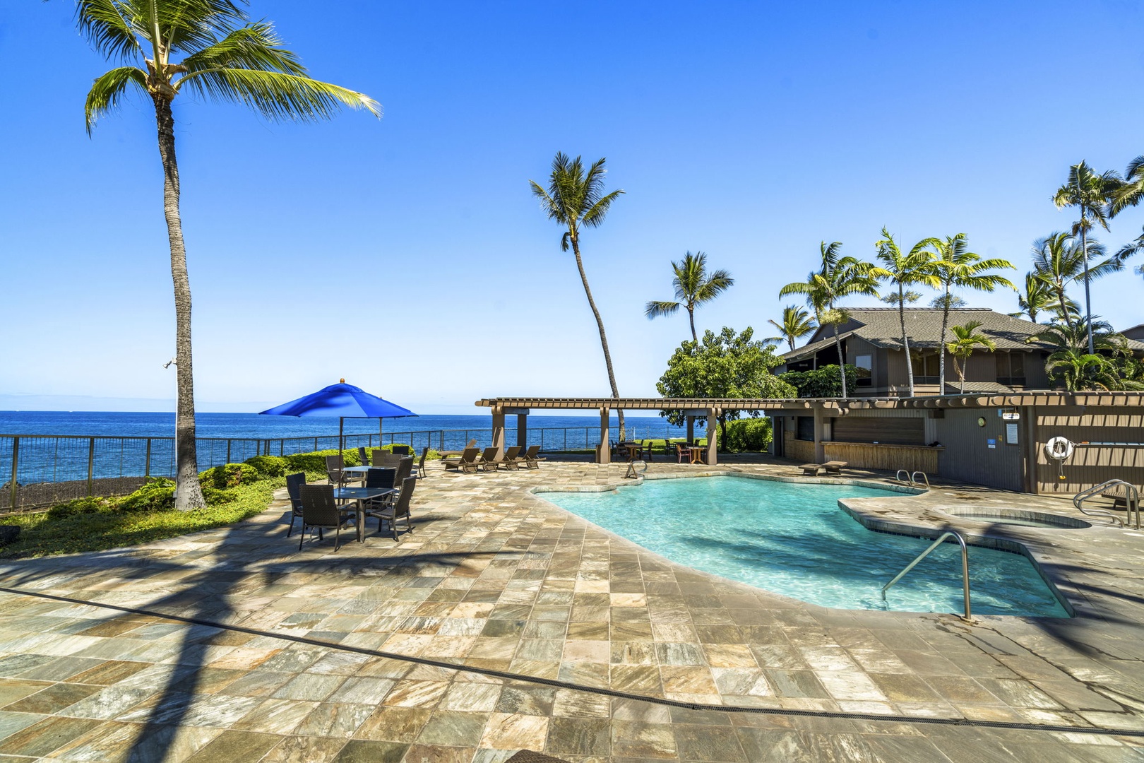 Kailua Kona Vacation Rentals, Kanaloa at Kona 1606 - An oceanfront pool where the blue of the water meets the blue beyond.