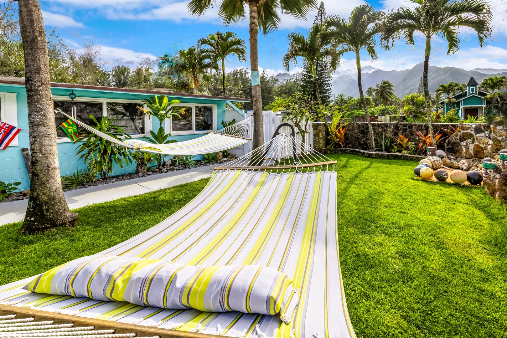 Hauula Vacation Rentals, Private Beach Paradise - Afternoons disappear in the hammock, palms overhead and the lawn sloping to the water.