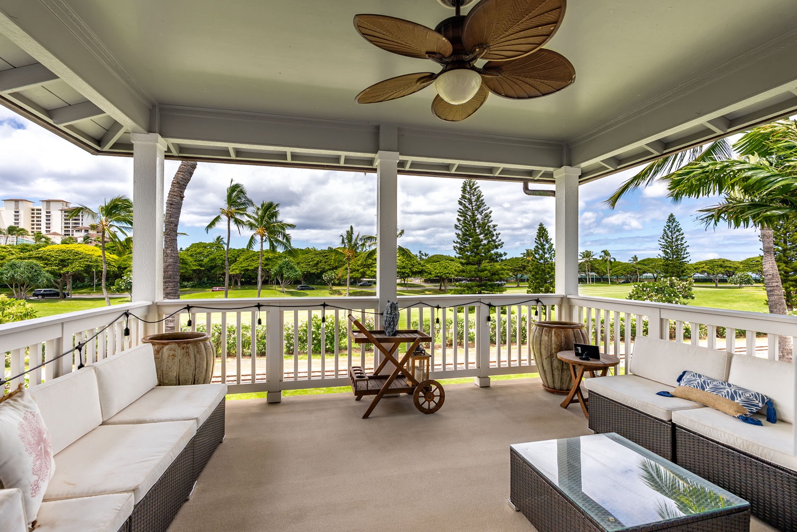 Kapolei Vacation Rentals, Coconut Plantation 1080-4 - The covered lanai runs long, shaded, and set for lingering over a slow dinner.