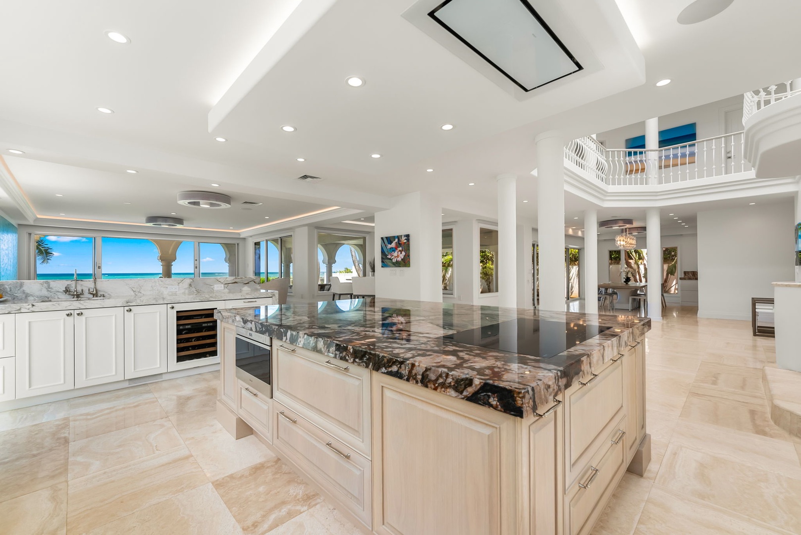 Kailua Vacation Rentals, Lanikai Sunrise Estate - Designer kitchen blending modern finishes with warm wood tones, set against panoramic windows.