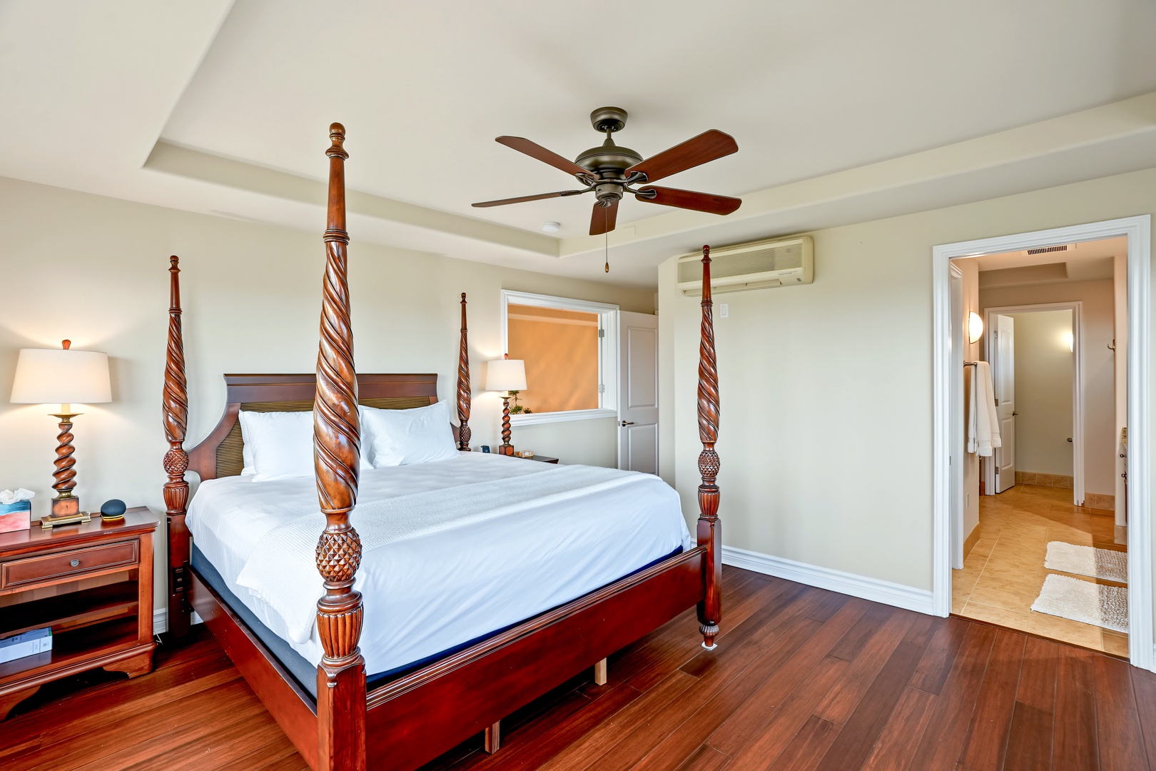 Princeville Vacation Rentals, Hale Hau'oli Moku - Turn in under the ceiling fan, with a nightstand and lamp on each side.