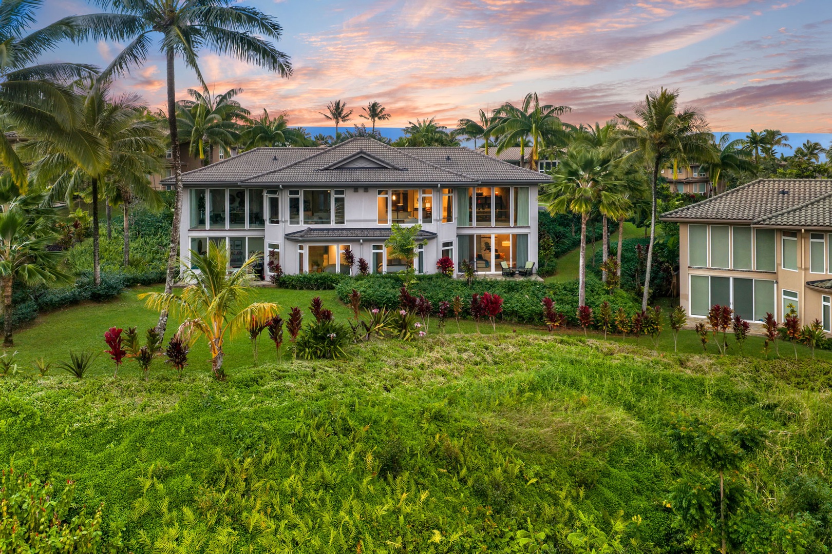 Princeville Vacation Rentals, Kaiulani #8 - Catch the last color of sunset from the lawn, palms framing the townhome.