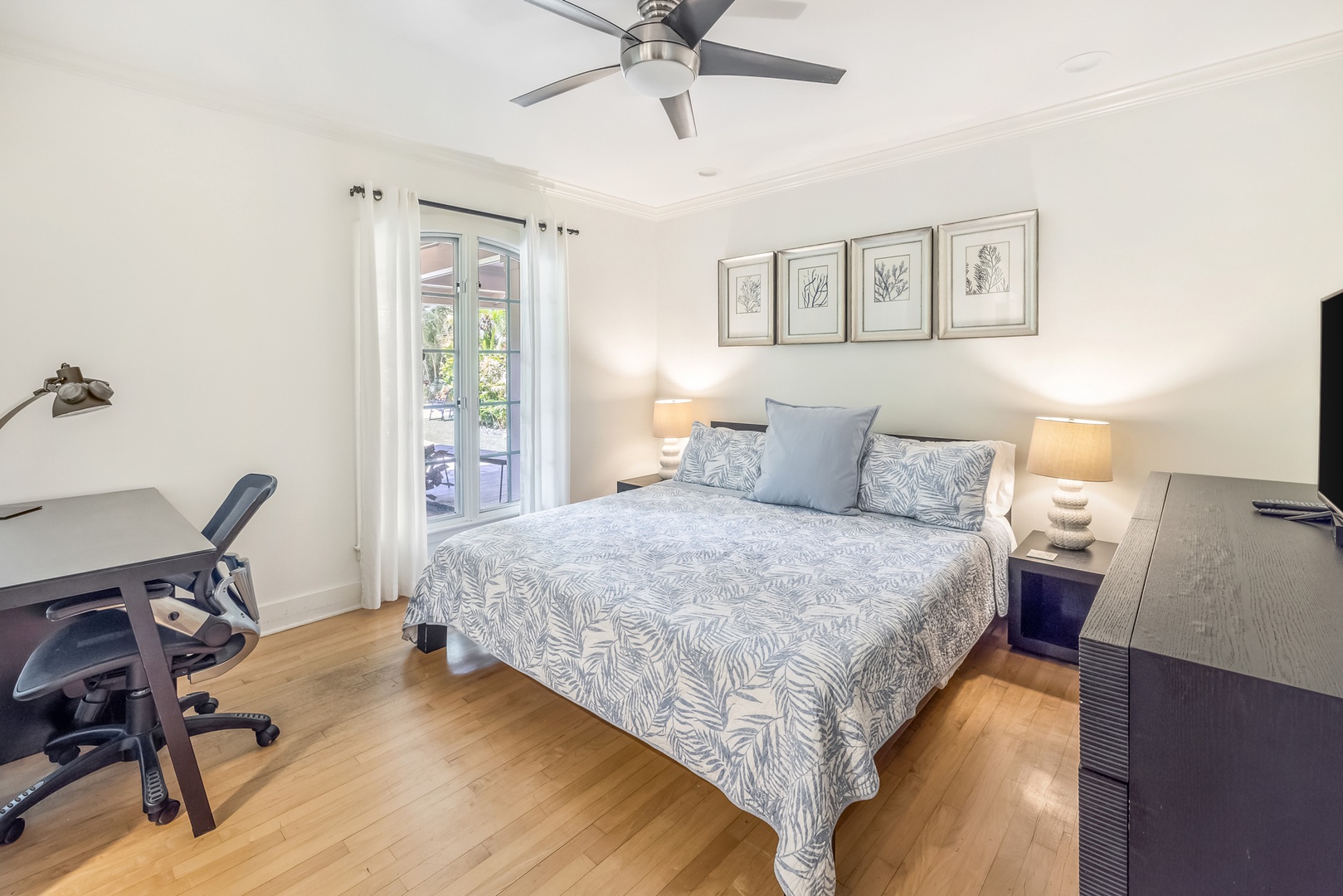 Honolulu Vacation Rentals, Moana Lani - Guest Bedroom 4 with king bed, ceiling fan, TV, ensuite, and plenty of natural light.