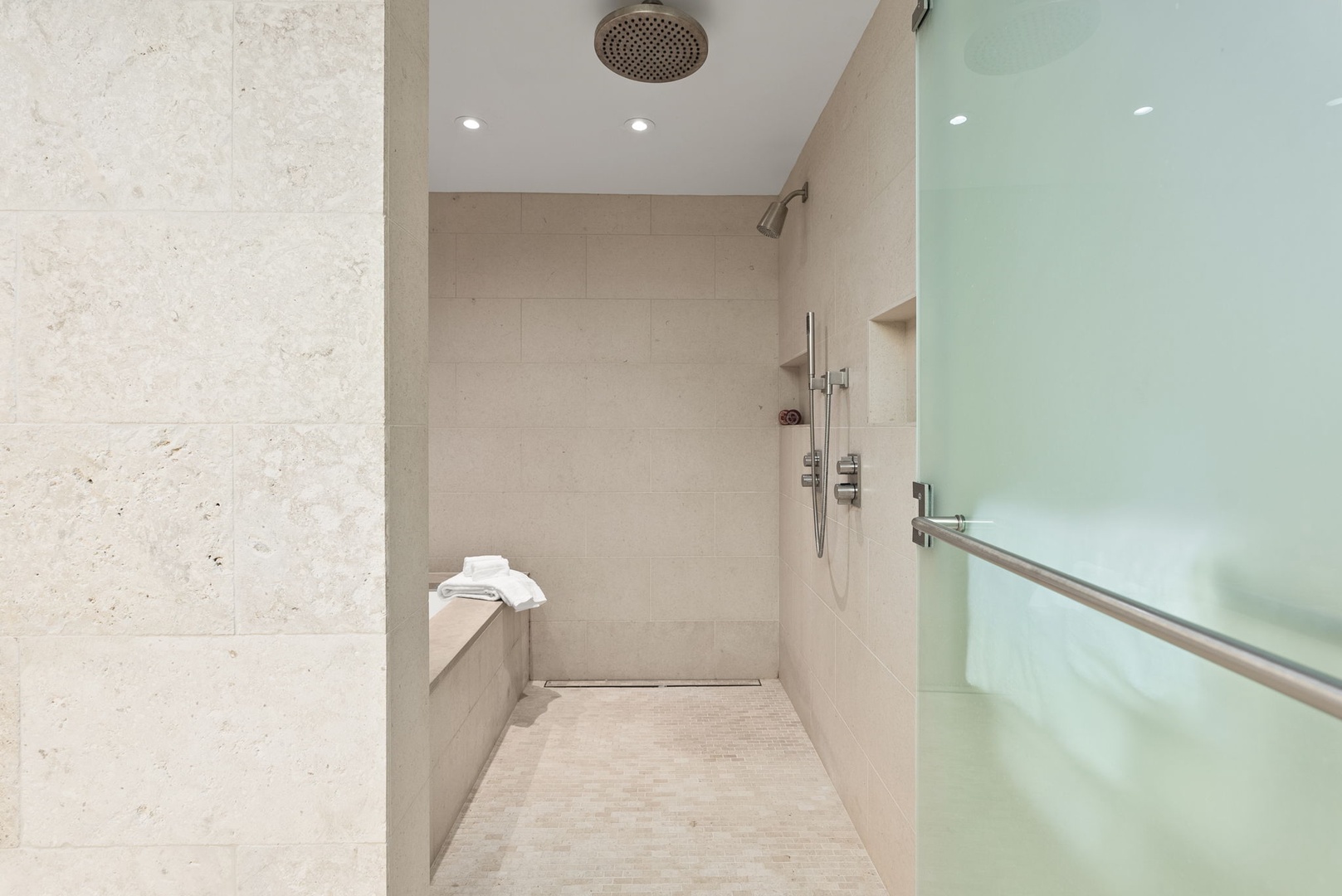 Honolulu Vacation Rentals, Park Lane Getaway - Walk-in shower with a rainfall showerhead, providing a refreshing and upscale bathing experience.