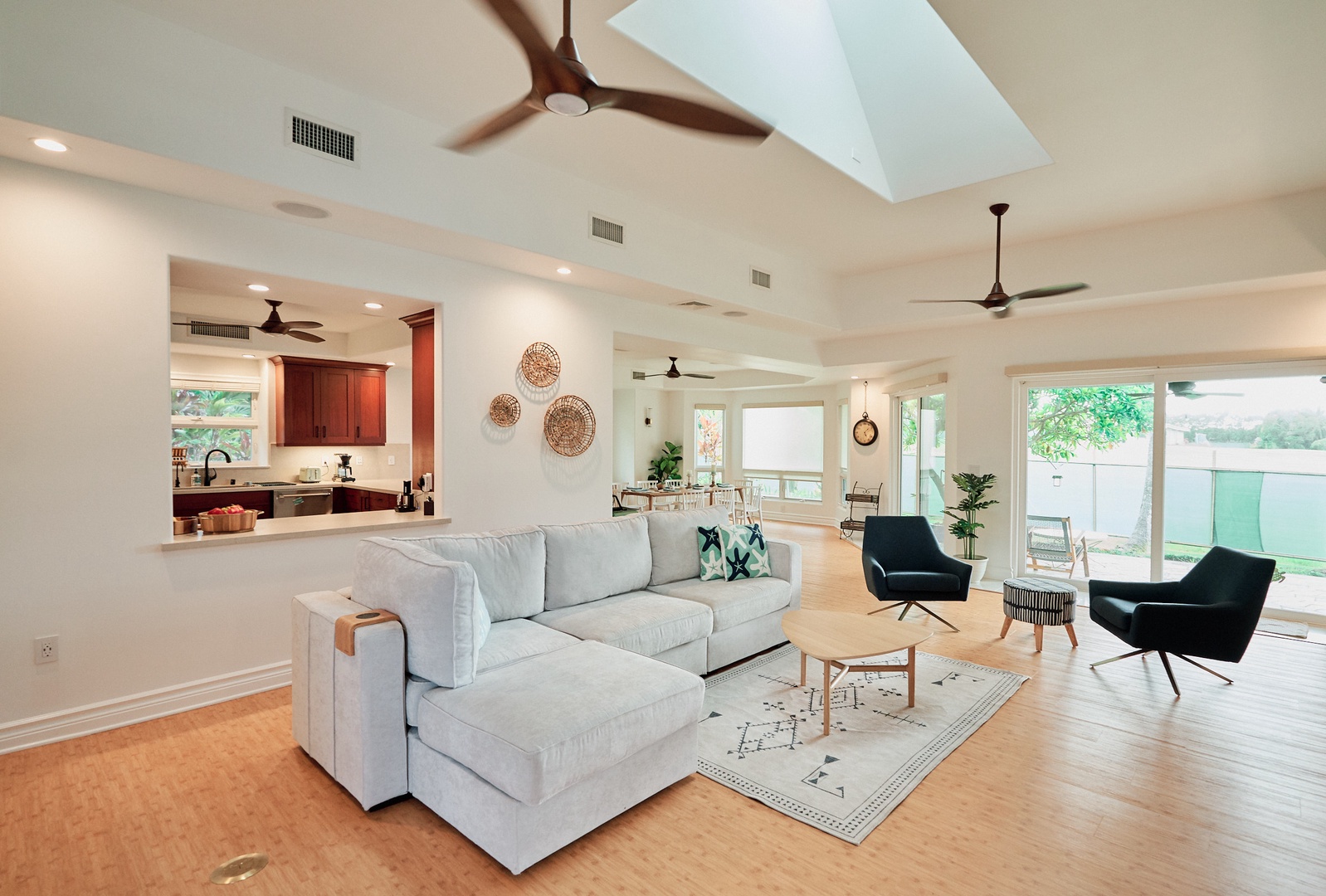 Princeville Vacation Rentals, Hale Kai - Spacious living room with soaring ceilings, modern furnishings, and seamless flow to the gourmet kitchen.