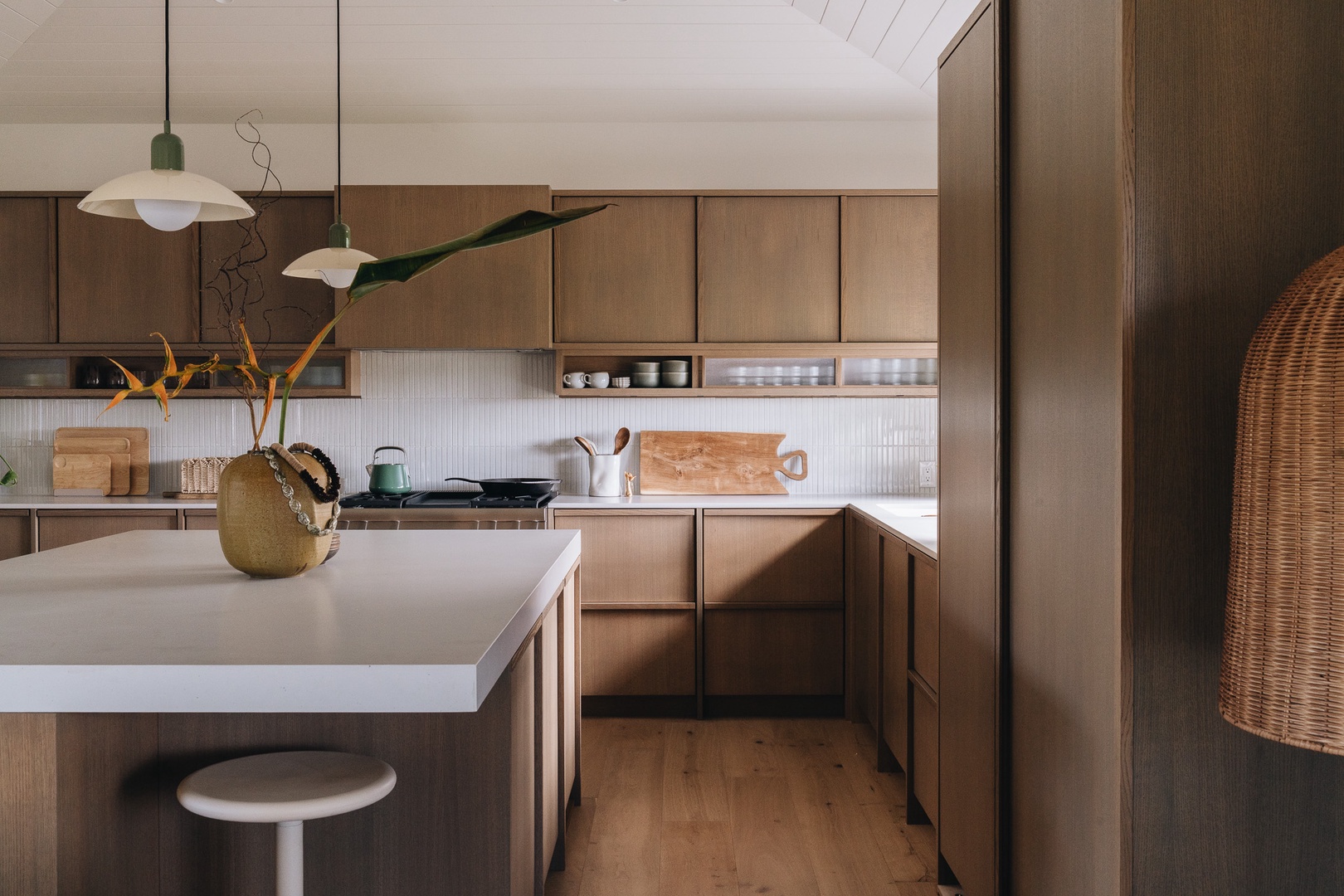Honolulu Vacation Rentals, Surfside Bungalow** - Warm wood cabinetry, modern appliances, and clean lines create a kitchen designed for both everyday living and entertaining.