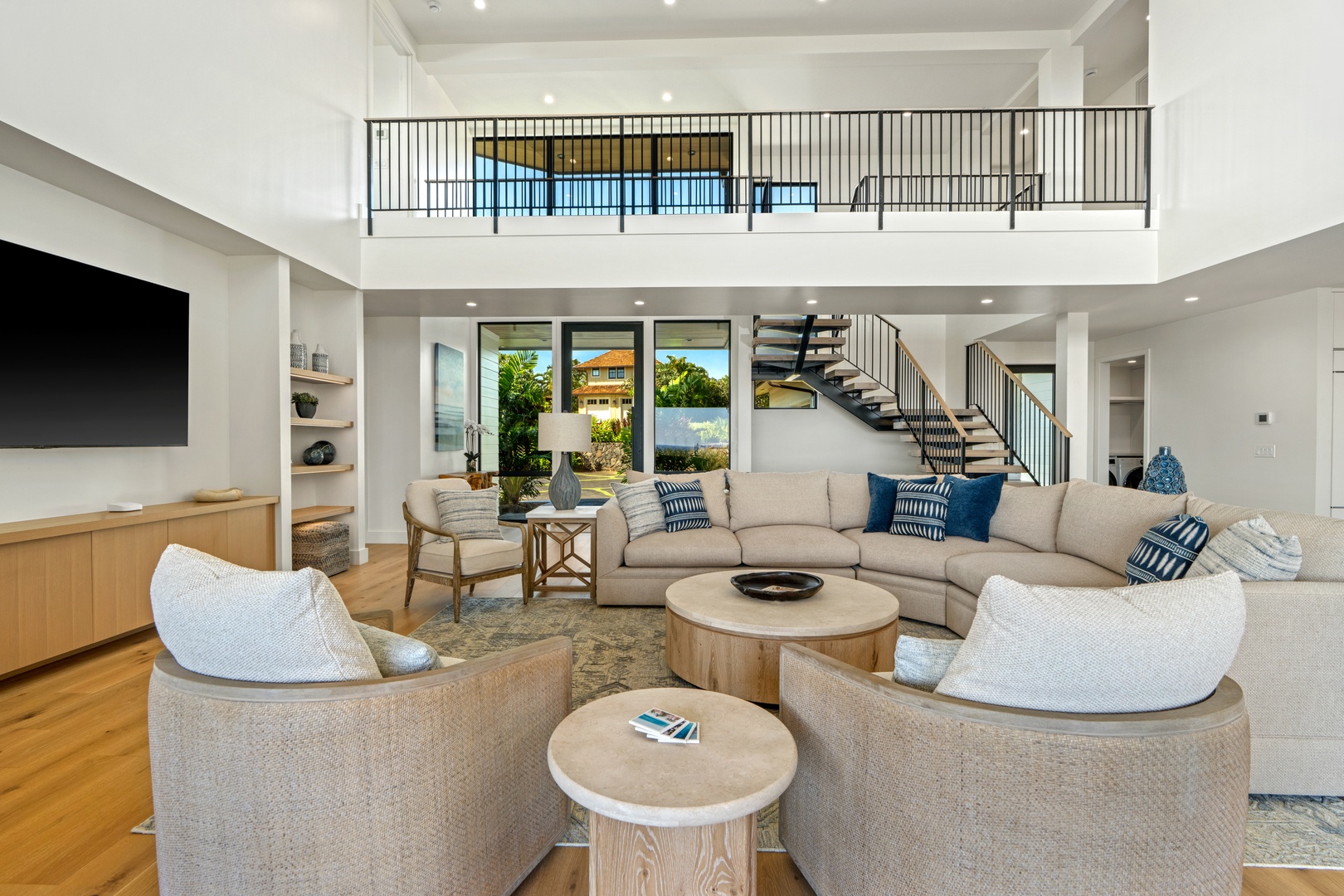 Koloa Vacation Rentals, Hale Laule'a at Kukui'ula - Sink into plush seating in your open-concept living area, where soaring ceilings and abundant natural light create an airy, sophisticated retreat.