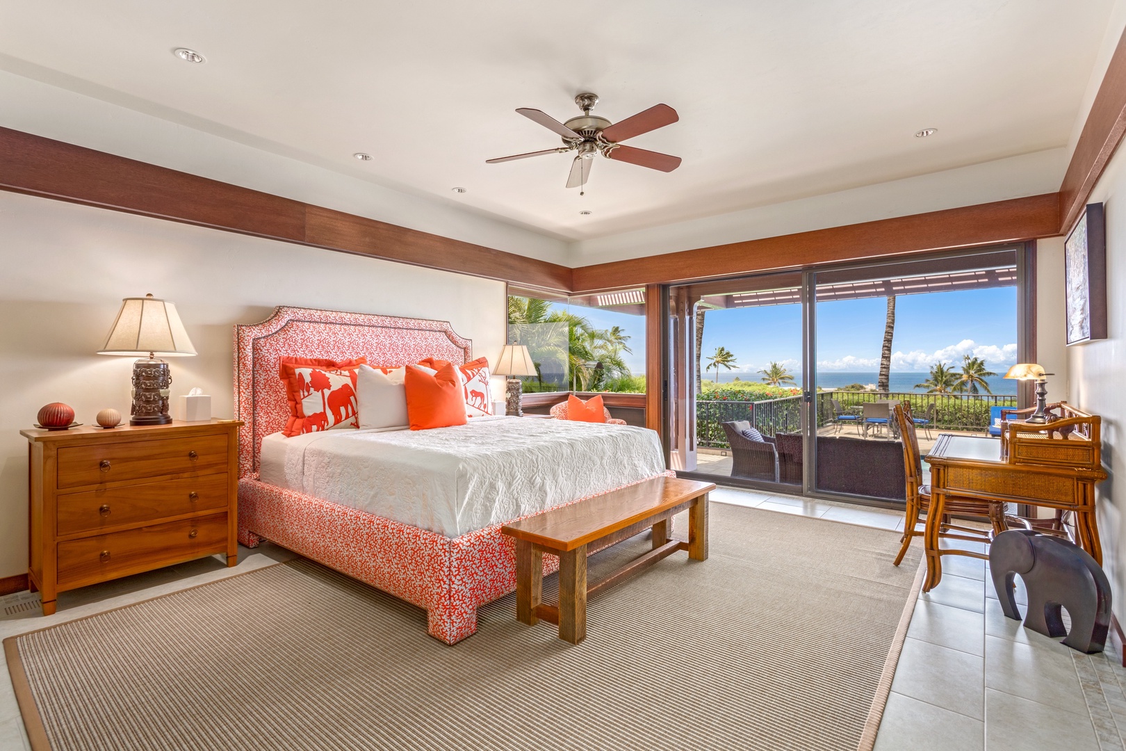 Kamuela Vacation Rentals, 3BD Villas (39) at Mauna Kea Resort - Primary bedroom suite with king bed, flat-screen TV, desk, sliding doors to deck seating, and en suite bath.