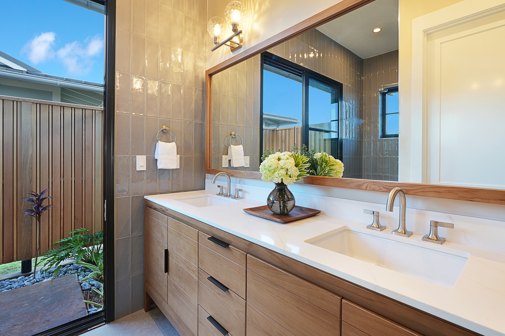 Koloa Vacation Rentals, Hali'a Mai - Its ensuite carries the same easy palette, double vanity and greenery just past the glass.
