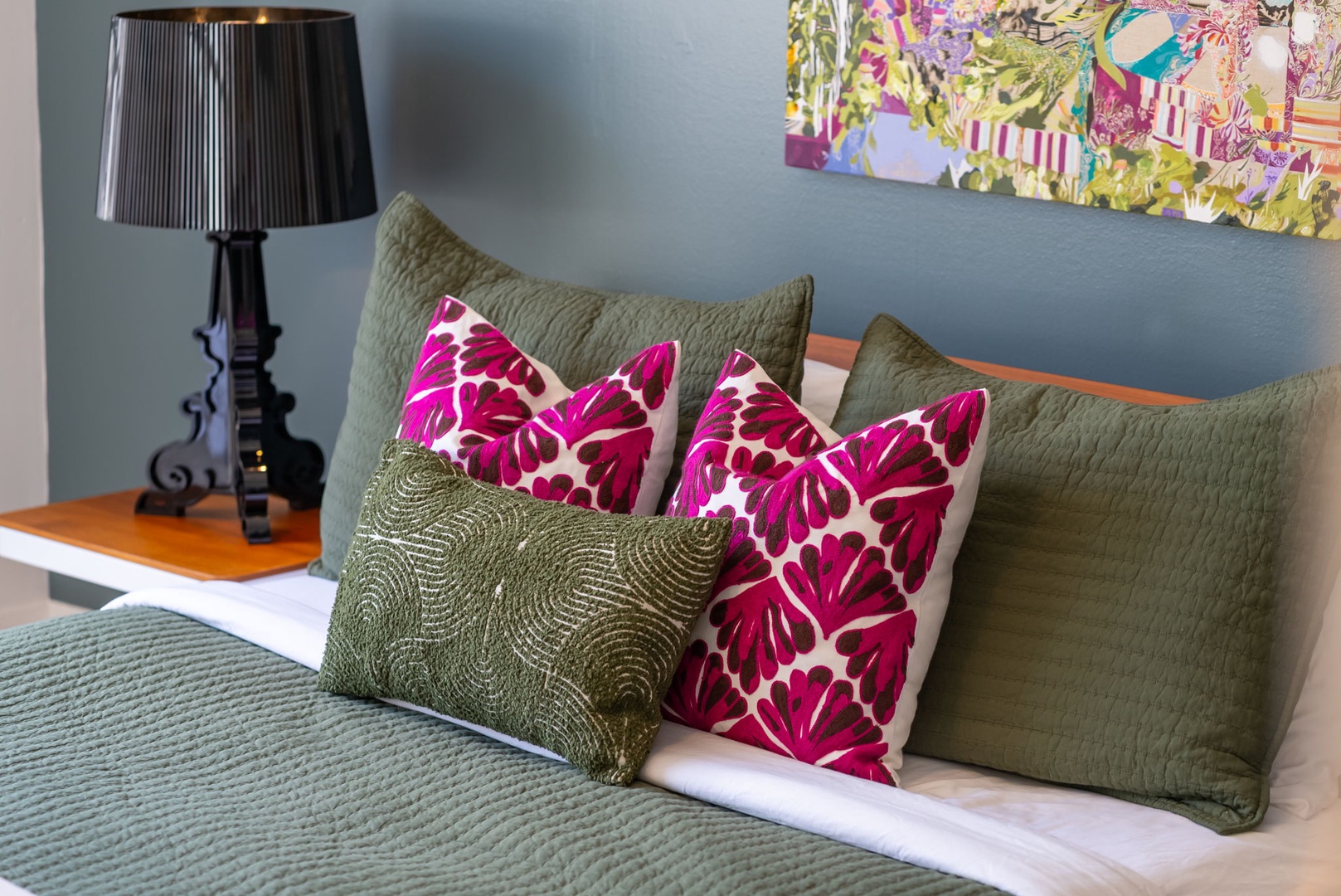 Honolulu Vacation Rentals, Ho'okipa Villa - Sink into a soft bed with vibrant accents and ambient lighting, where your peaceful retreat awaits in a thoughtfully styled bedroom.