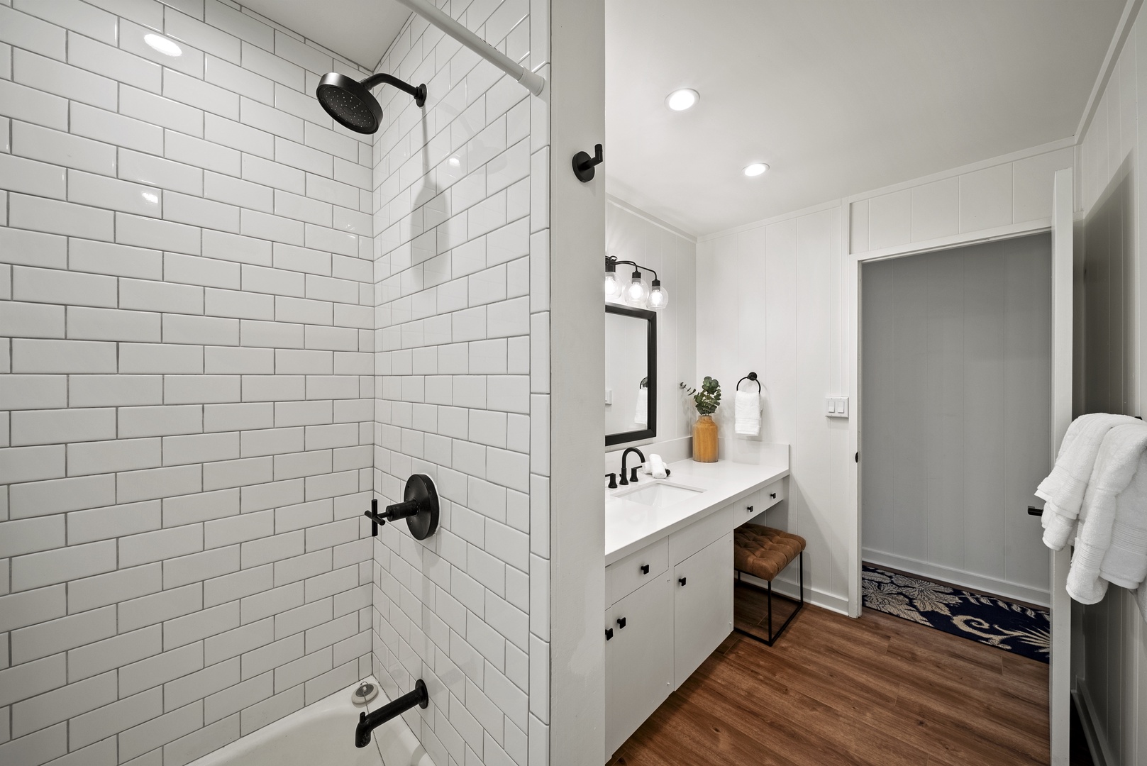 Honolulu Vacation Rentals, Honolulu Beachfront Retreat - Walk-in shower with dark fixtures and timeless subway tile, blending contemporary design with beachside relaxation.