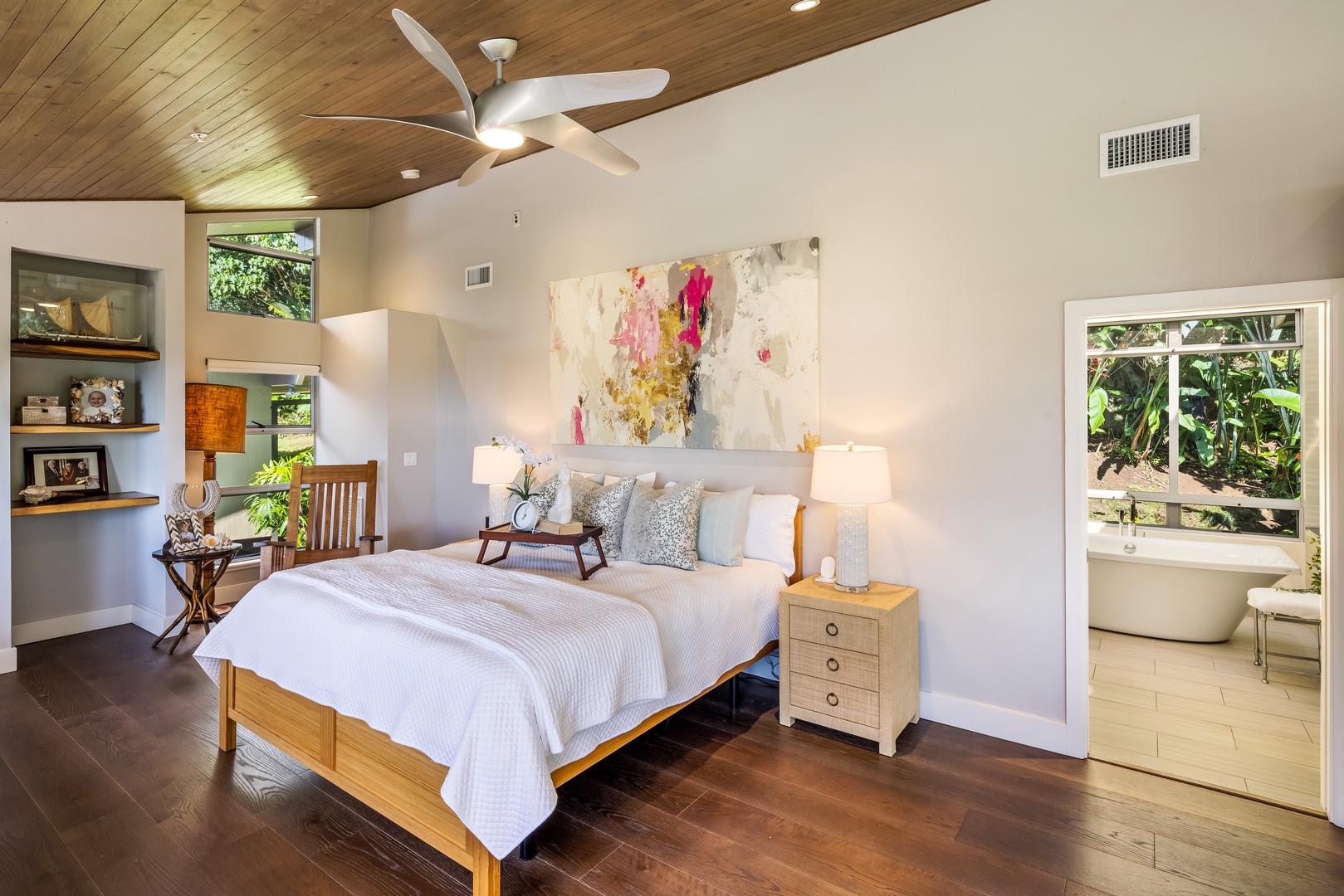 Honolulu Vacation Rentals, Manoa Royal Retreat - Wake up in luxury in this bright primary suite with ensuite bath and natural wood details.