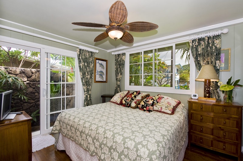 Haleiwa Vacation Rentals, Sunset Point Hawaiian Beachfront** - Primary bedroom with large windows.