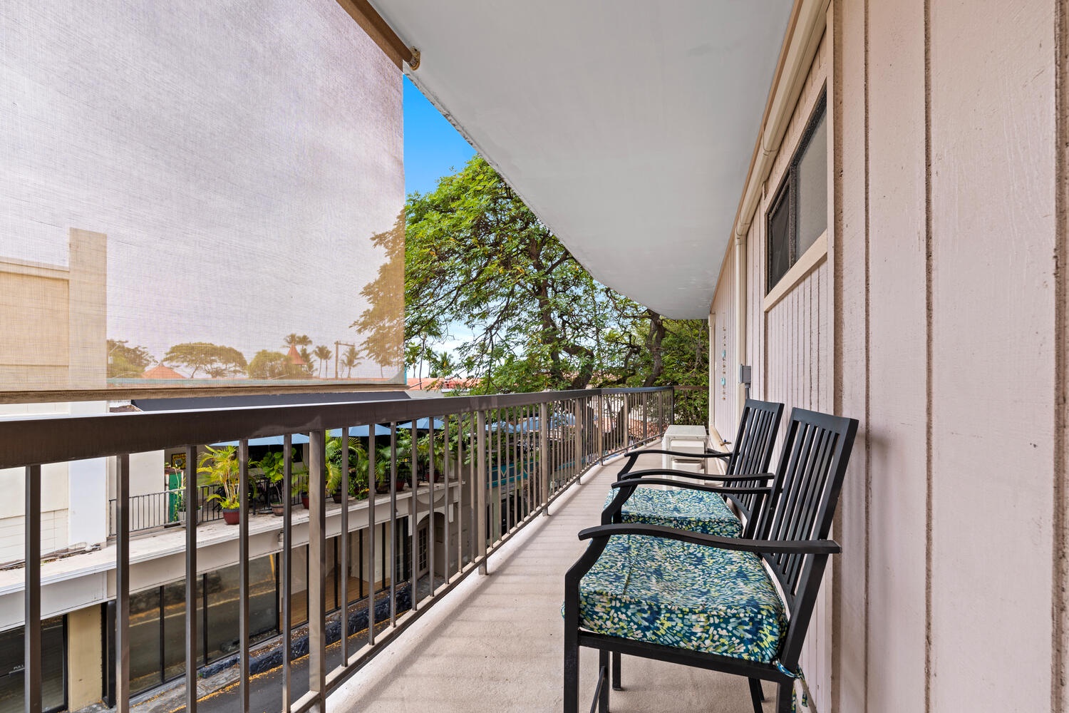Kailua Kona Vacation Rentals, Kona Plaza 201 - Step onto your private lanai and settle into comfortable chairs while enjoying peaceful views of lush tropical greenery.