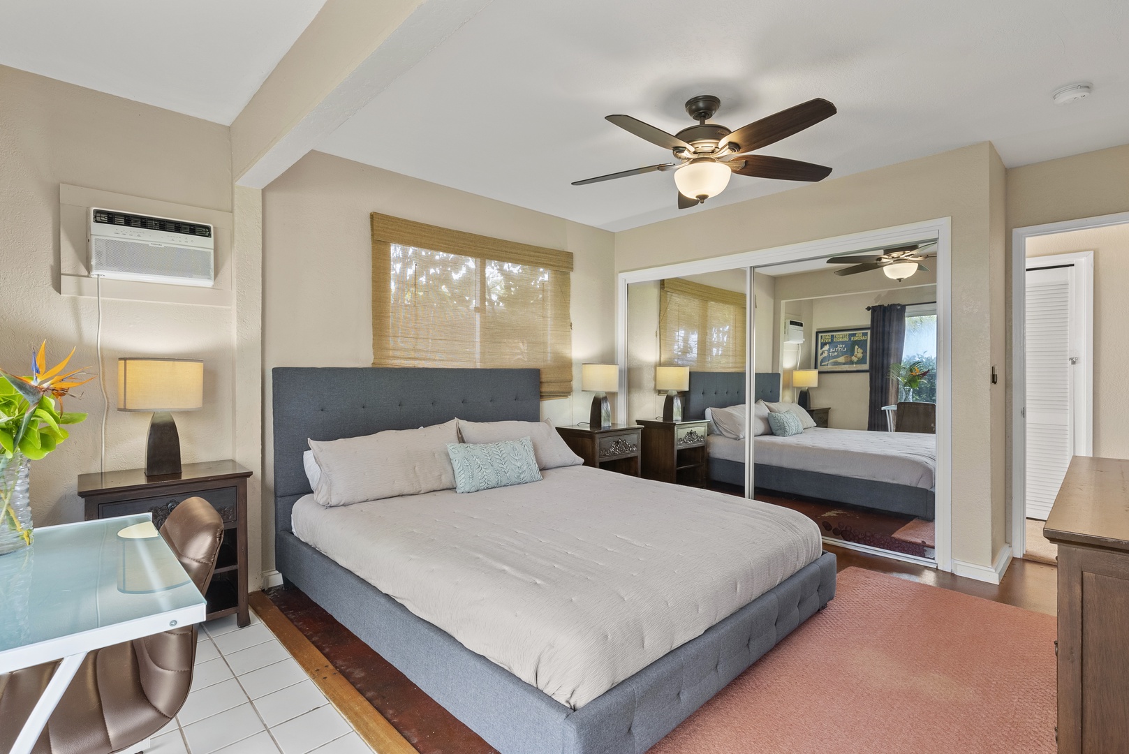 Haleiwa Vacation Rentals, North Shore Beachfront Retreat - Guest bedroom with a king-size bed, outdoor access, and peaceful garden views.