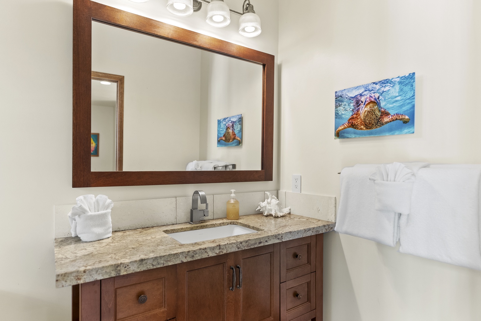 Haleiwa Vacation Rentals, Maluhia Beach House - Bright and stylish bathroom with a spacious vanity and elegant wood accents.