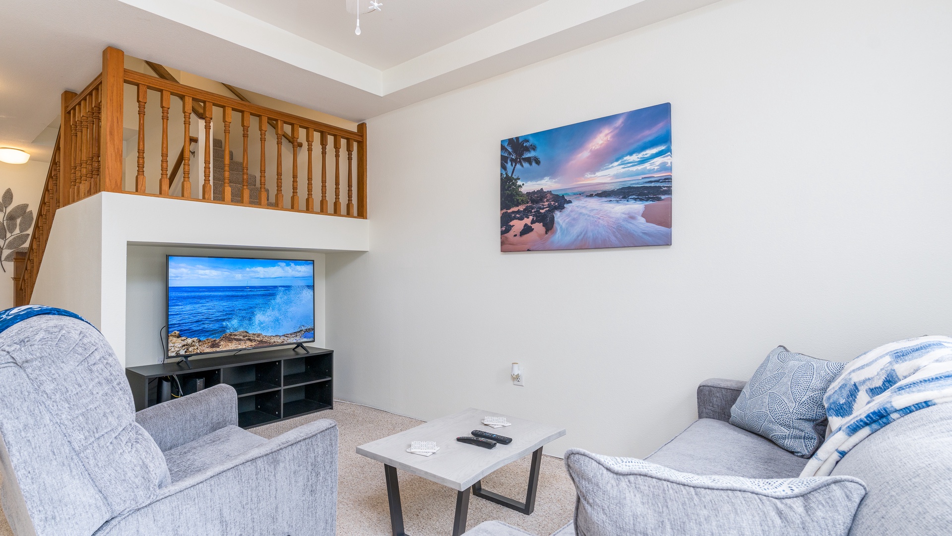 Kapolei Vacation Rentals, Fairways at Ko Olina 27H - Sink into the plush seating in the living area surrounded by natural wood tones.
