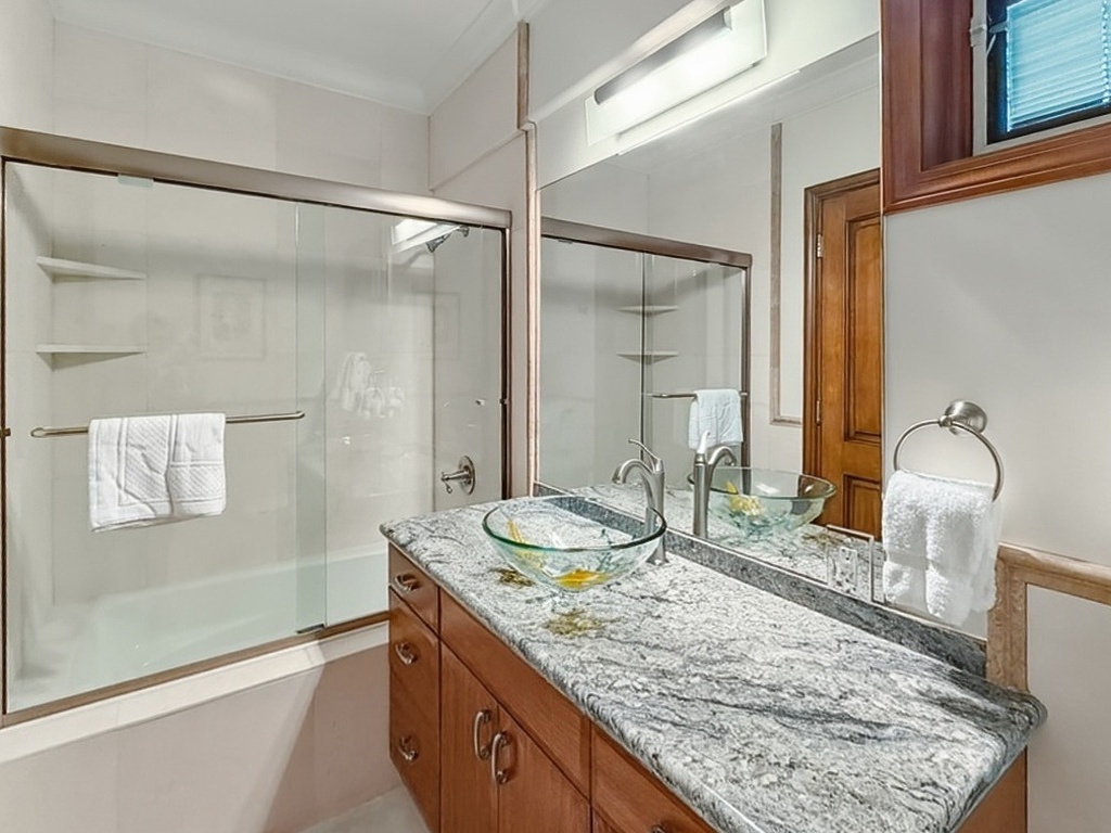 Honolulu Vacation Rentals, Maunalua Estate - Indulge in luxury with your stunning granite vanity and elegant glass vessel sink. Soft towels await your arrival in this spa-like retreat.