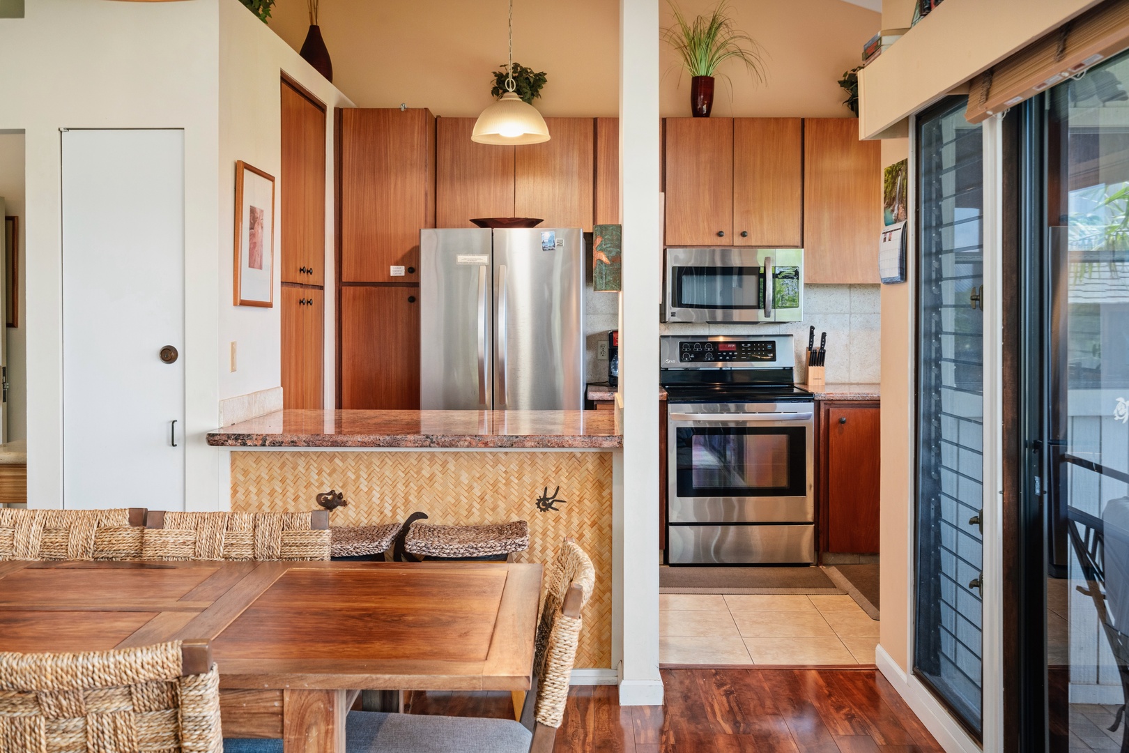 Kihei Vacation Rentals, Wailea Ekolu 204 - Slide onto a stool at the woven counter and hand plates over while dinner finishes cooking.