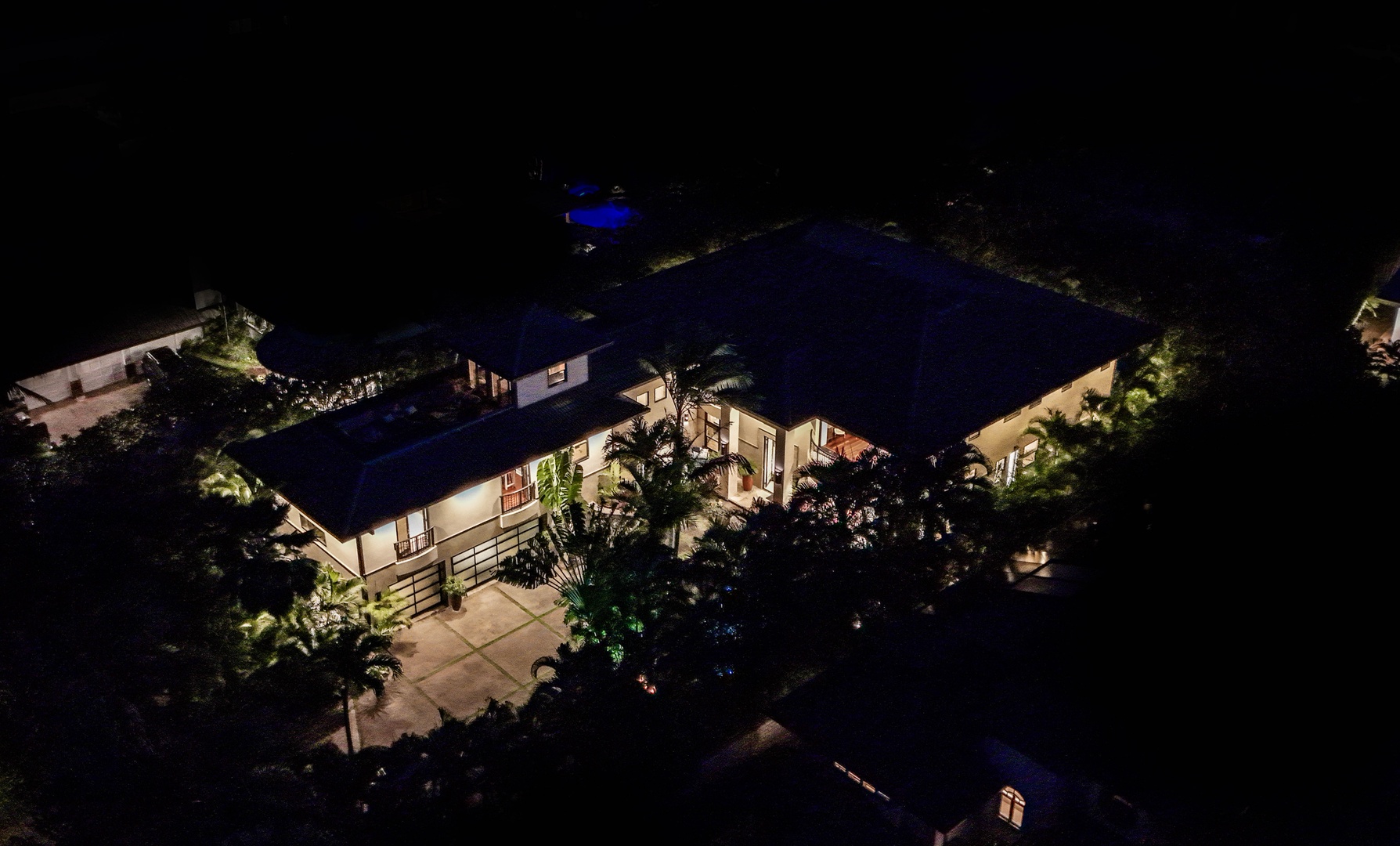 Honolulu Vacation Rentals, Pili Pono - Nighttime aerial view of Pili Pono glowing beneath the palms.