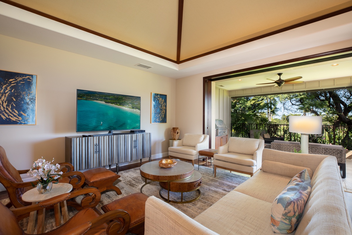 Kamuela Vacation Rentals, Mauna Lani KaMilo #123 - Here, a spacious living area with a sprawling TV set, plush sofas, and an open access to the lanai  invites you to unwind and feel right at home.
