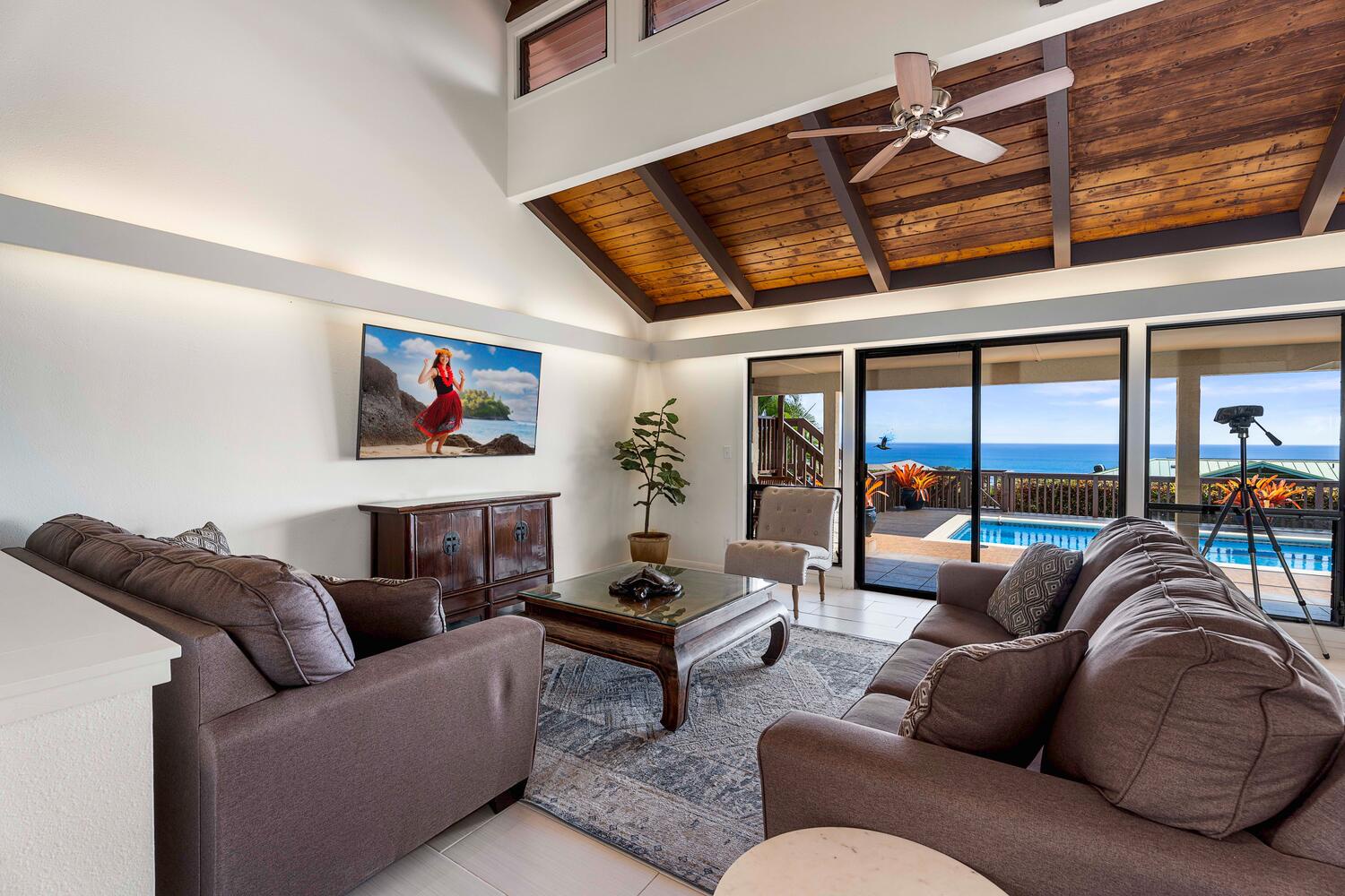 Kailua Kona Vacation Rentals, Kona Dreams - Lounge in the living area with plush sofas, high ceilings, TV and ocean views.