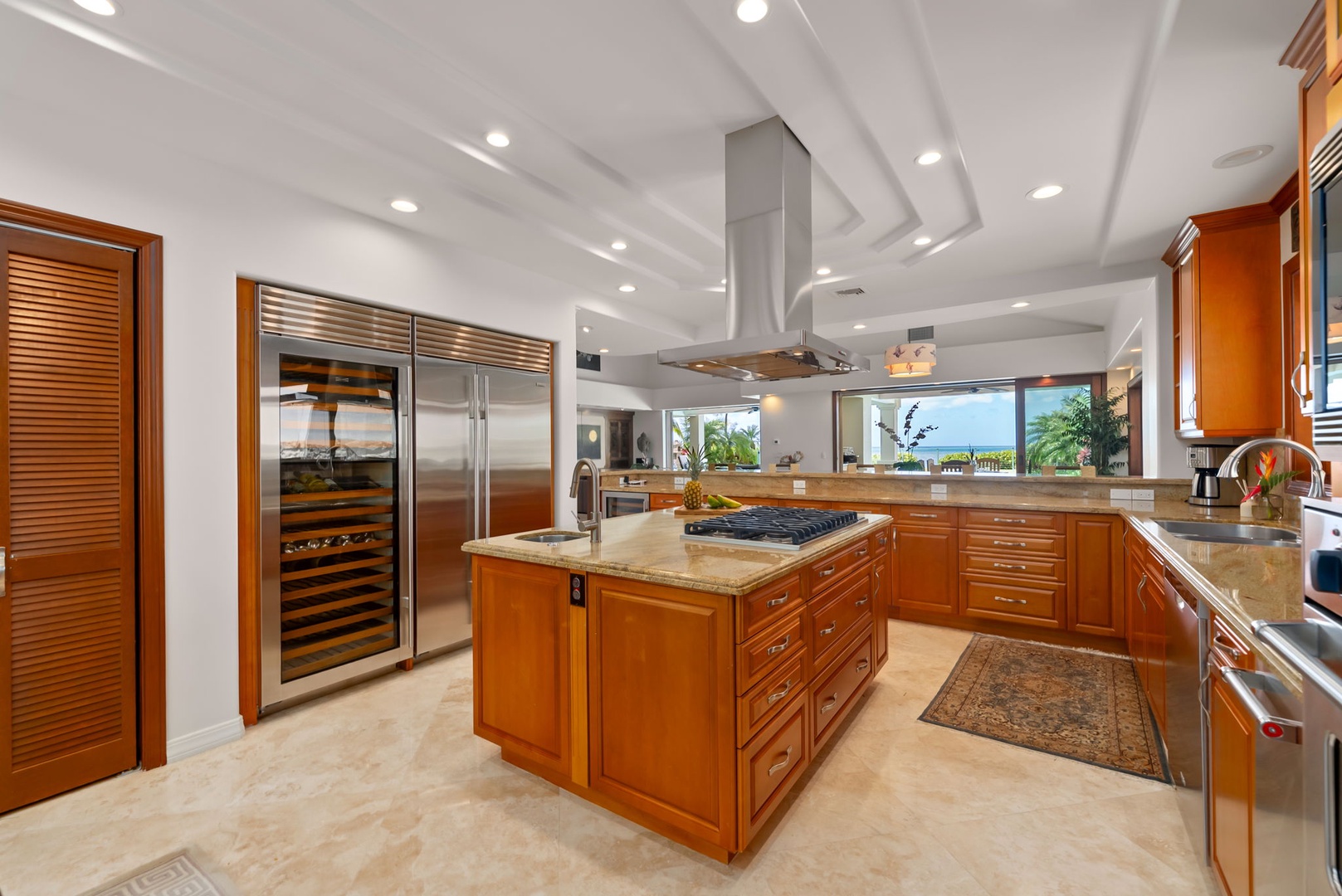 Honolulu Vacation Rentals, Maunalua Estate - Rich cabinetry, oversized islands, and soft natural light create a welcoming space for cooking and connection.